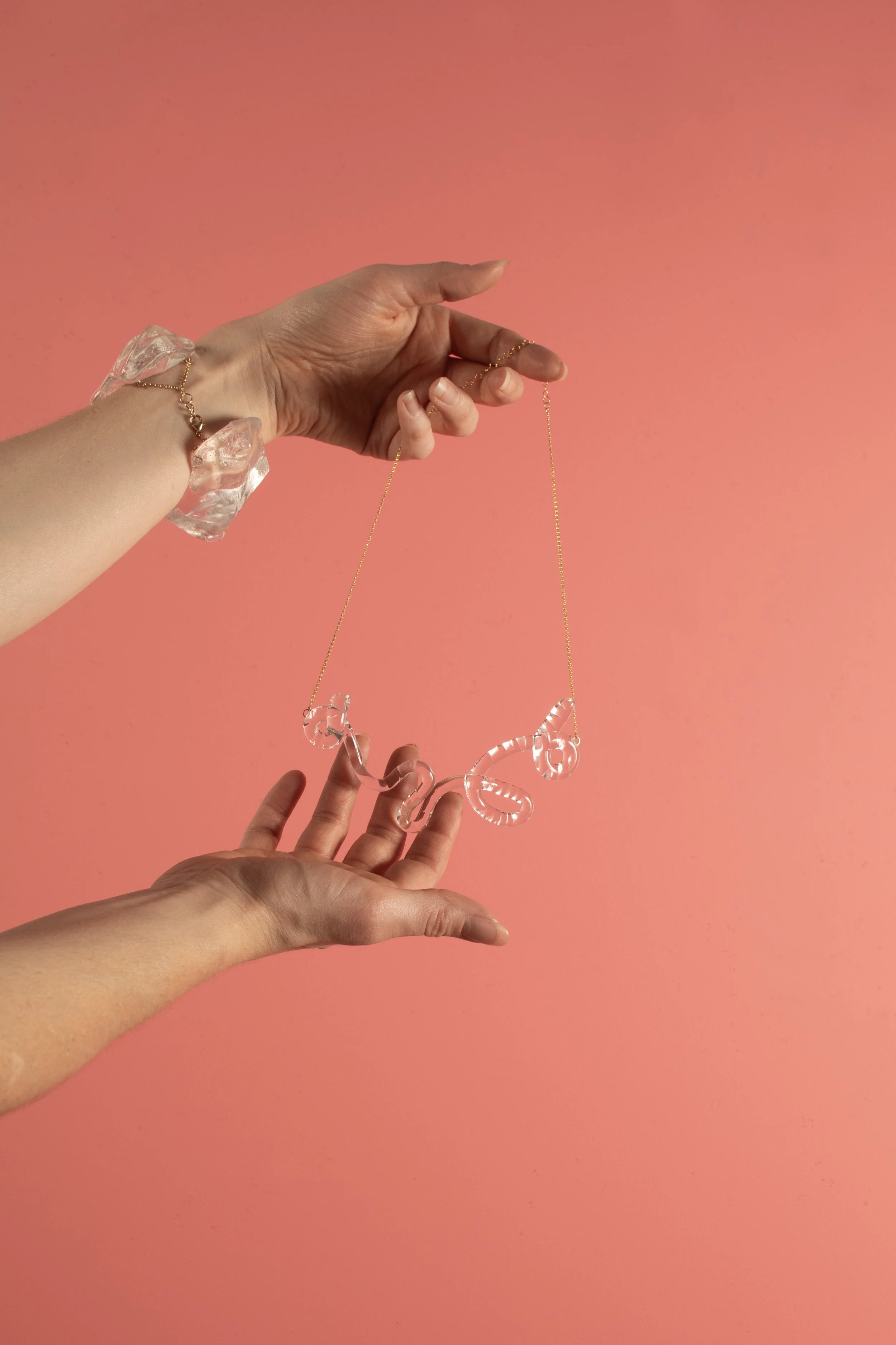 squigglyclear_withhand_onpink.jpg