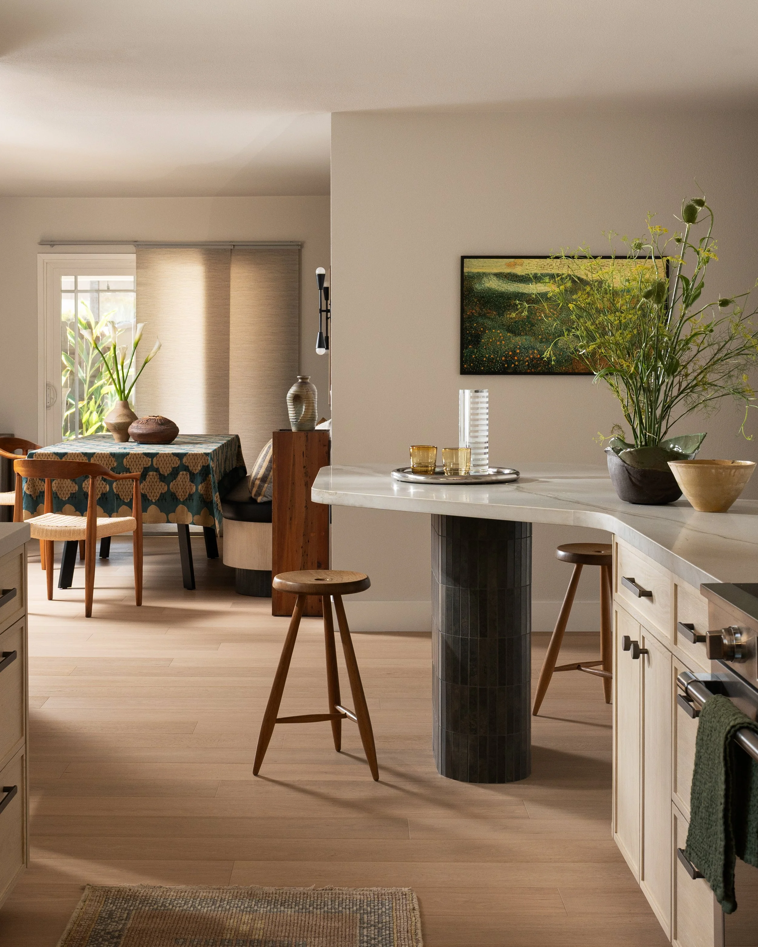 curvy peninsula with white oak kitchen cabinets