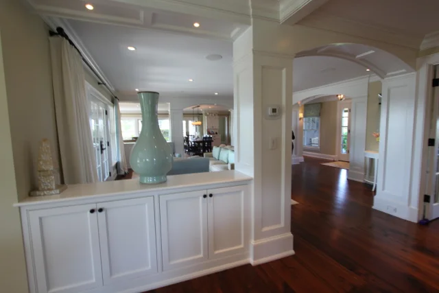 Hallway with built-in cabinets and green vase