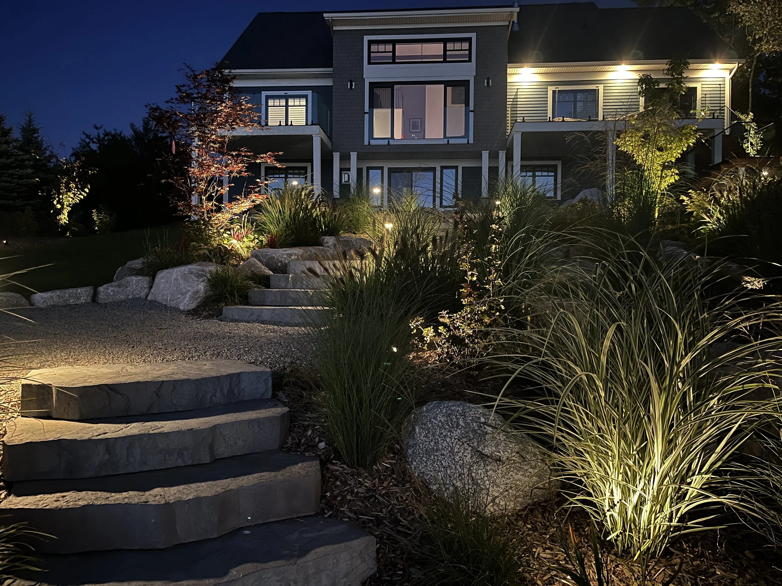 I achieved this romantic effect by downlighting the edges of the stone staircase & uplit the ornamental grasses to create a soft spill of colour & texture.