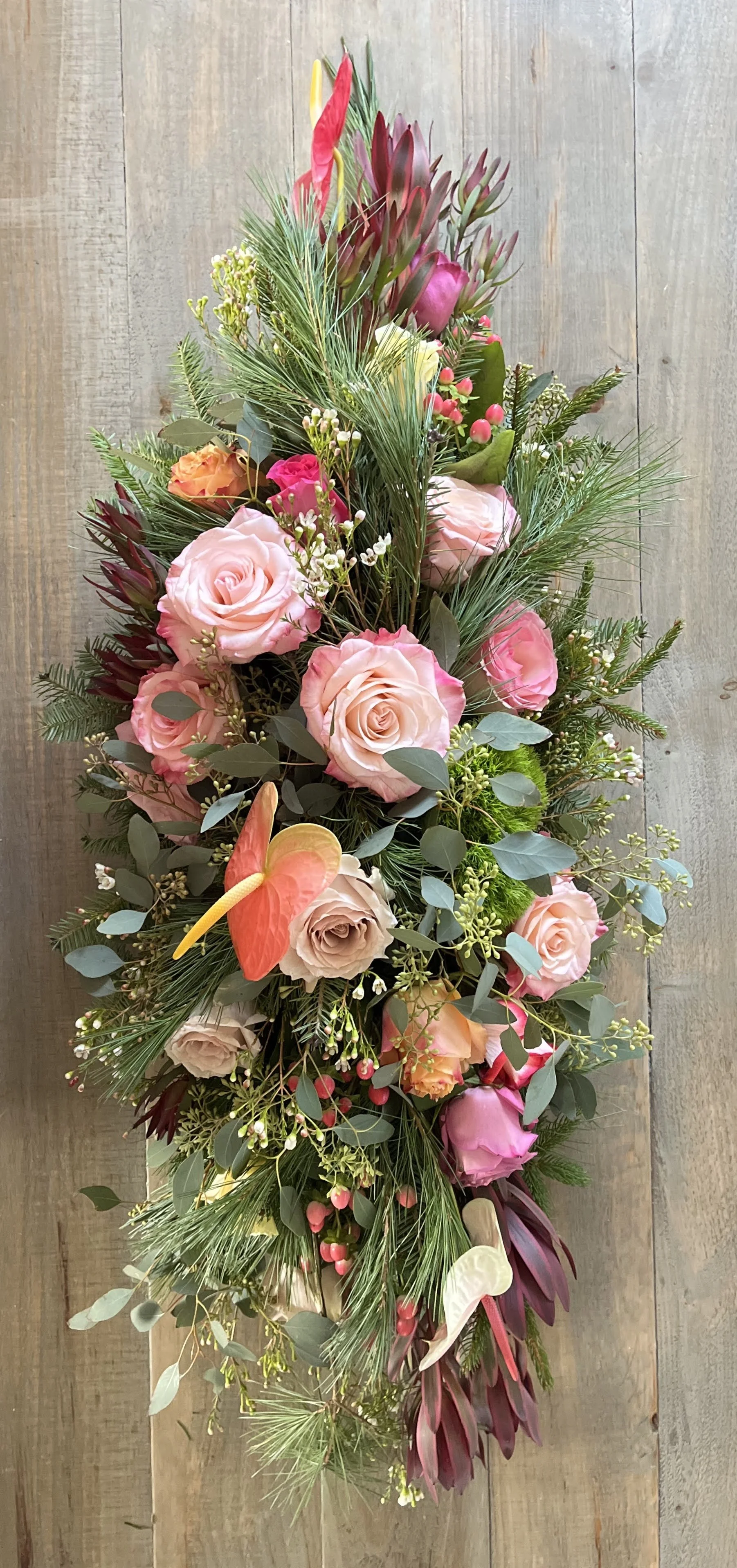 Table centerpiece #2 is full of robust seasonal flowers; cabbage roses, dianthus, leucadendron, hypericum, antherium, waxflower and fresh greens.