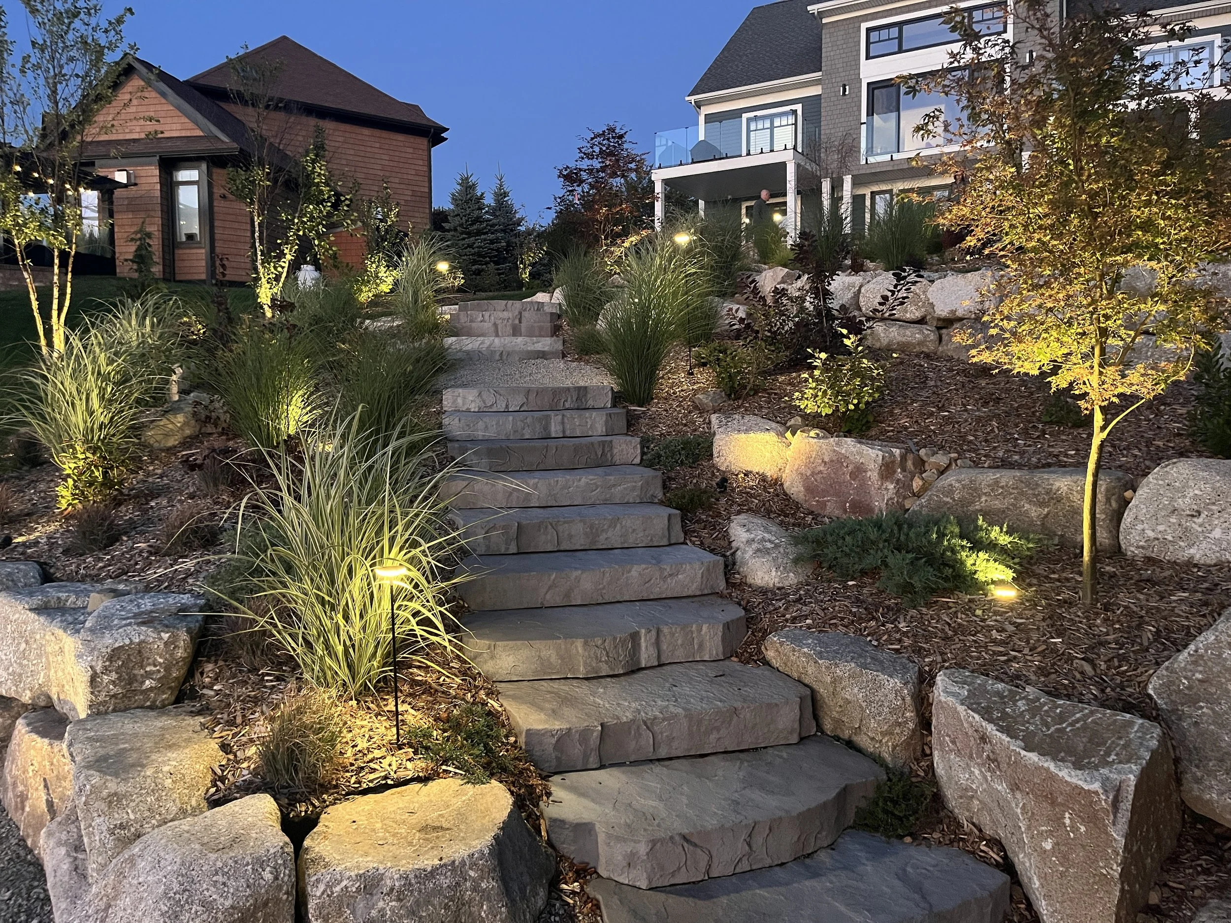 Approximately 30 spot & inground lights were used to illuminate the terraces of this lakeside landscape.