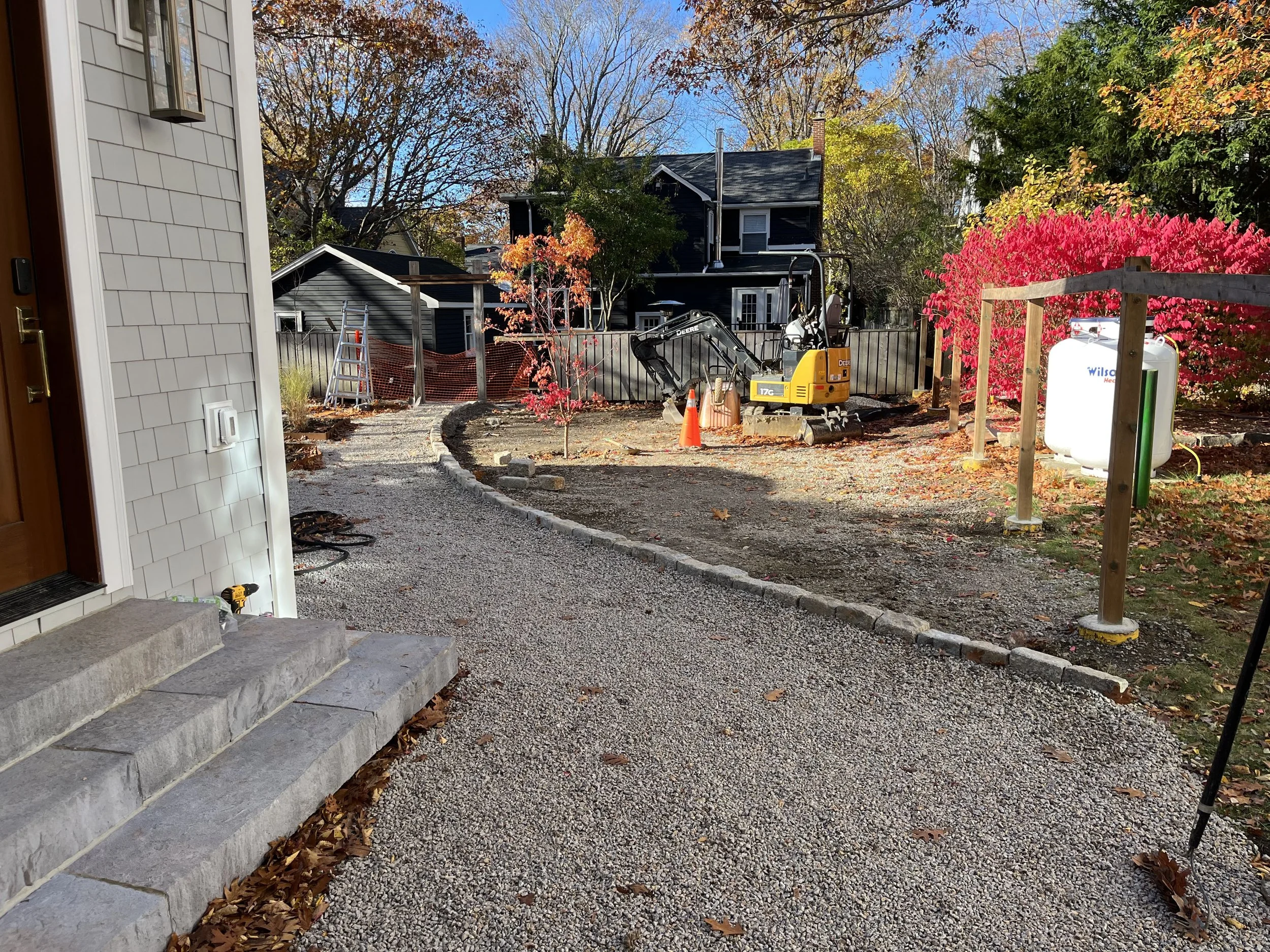Just prior to completing the landscping, wiring and light fixtures are placed so they can be buried under sod & alongside hardscape.