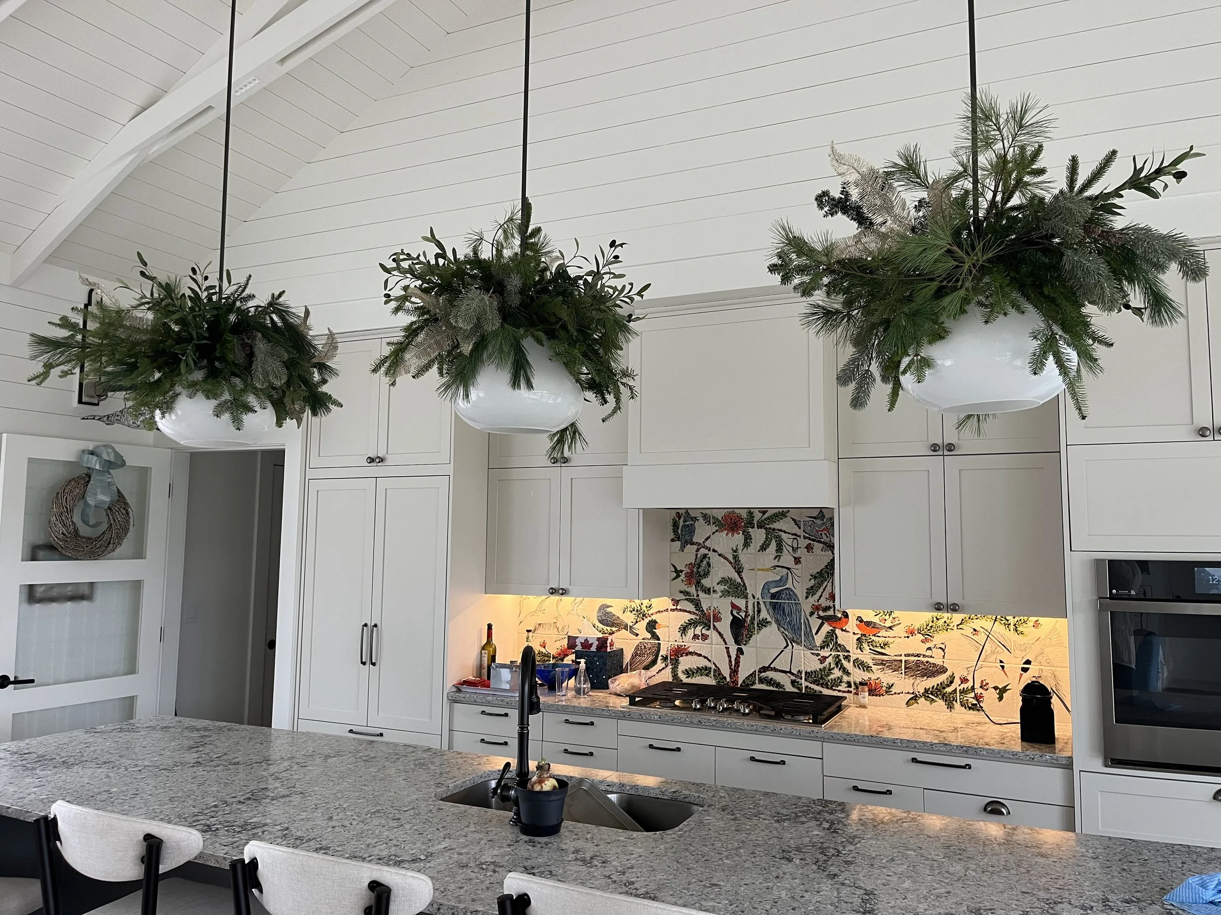 Pendants are hung with fresh and faux greens. 