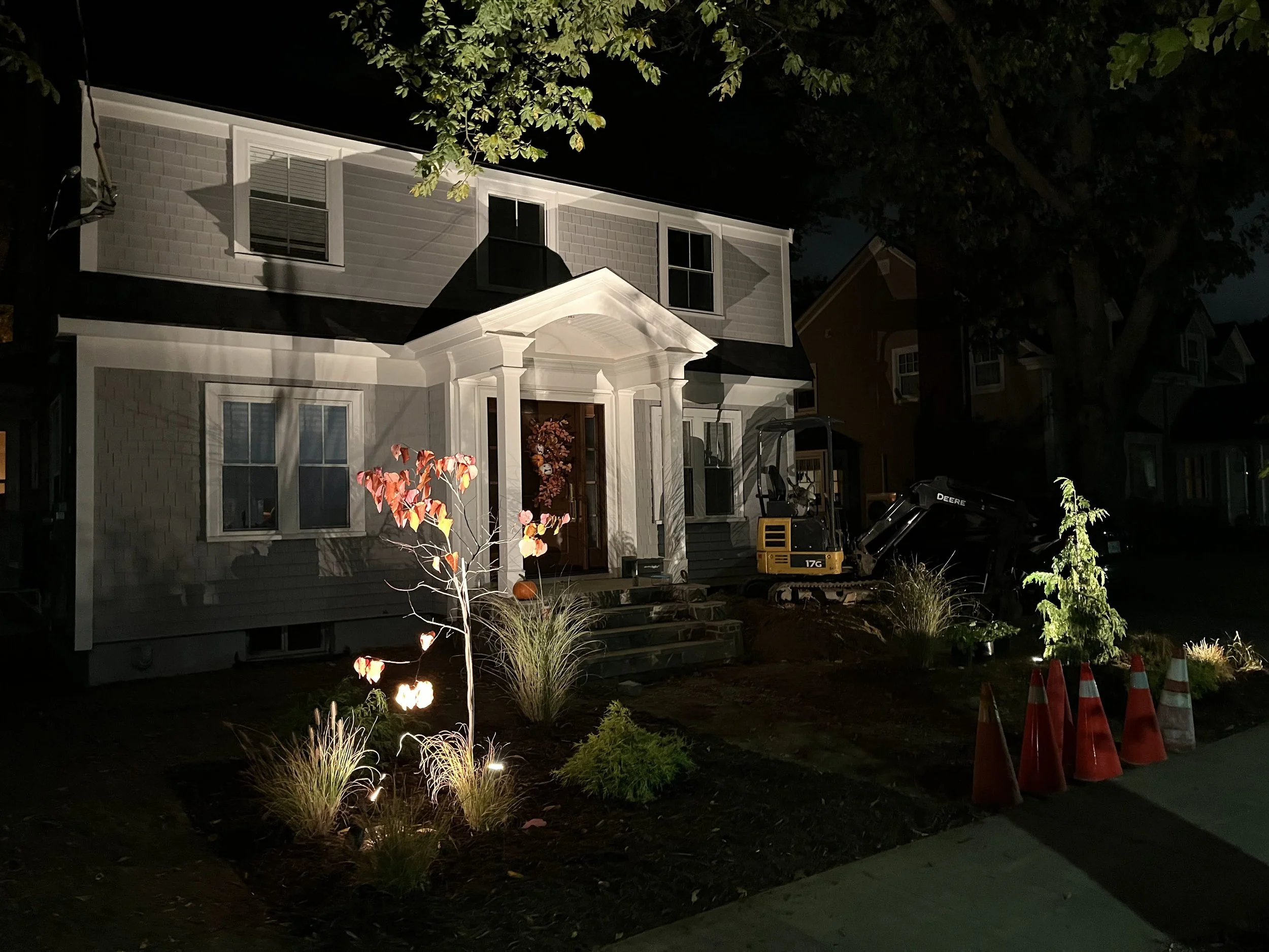 The lighting in a newly planted garden in Halifax' south end casts complext shadows on the front of the house. 