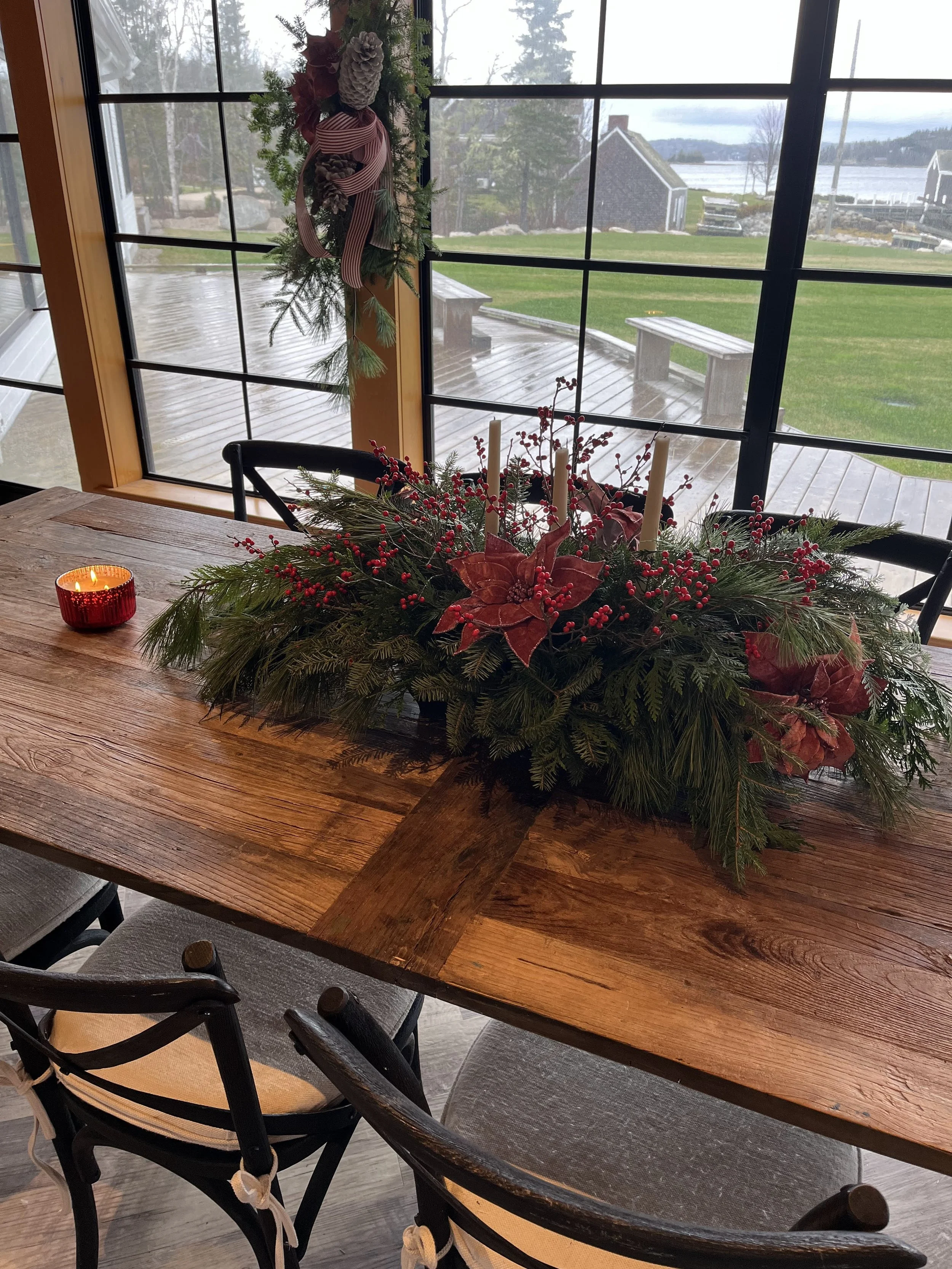 Table centerpiece #1 in the common room full of natural greens & velvet poinsettia. 