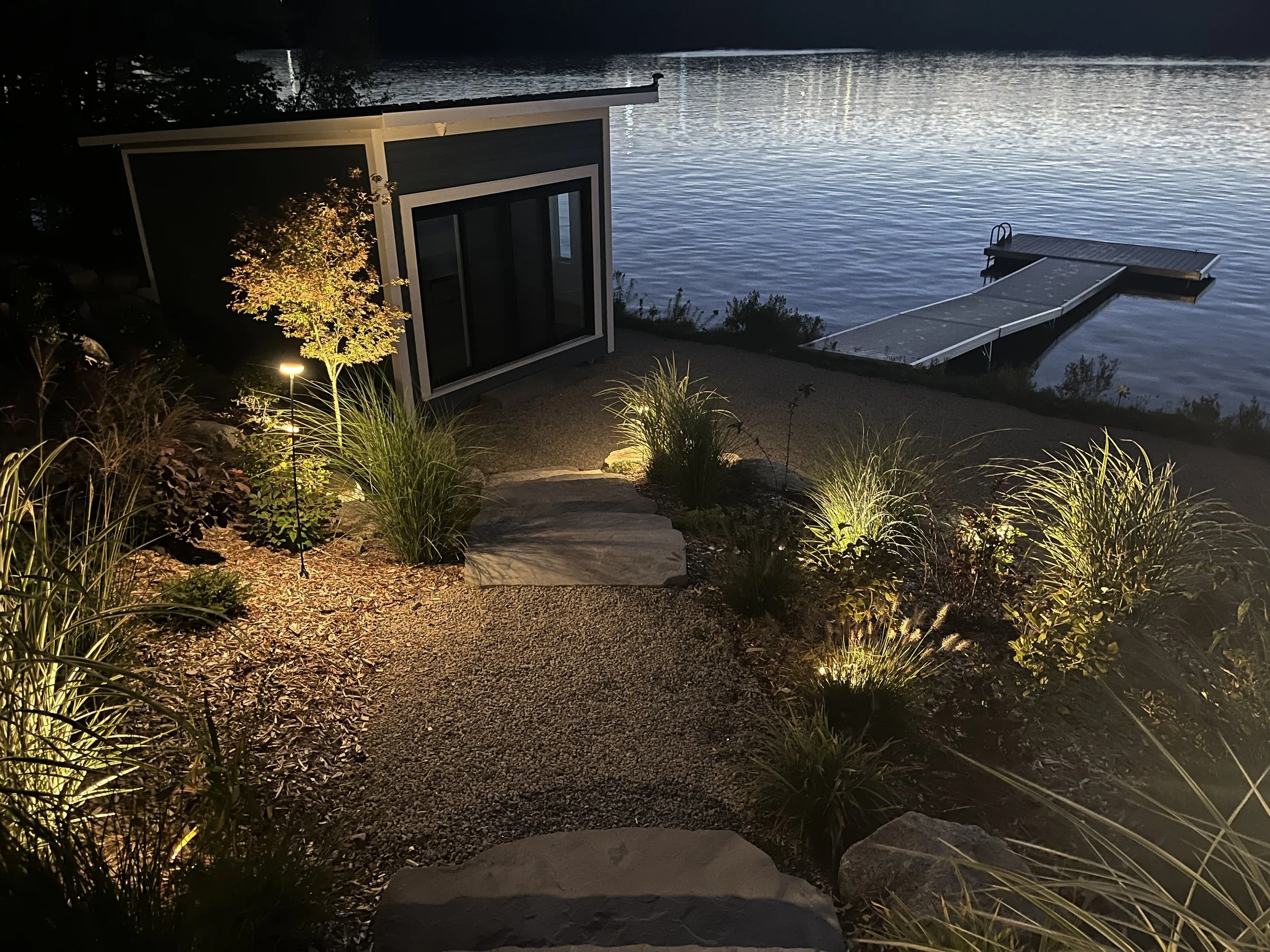 The evening view down to the boathouse & lake evokes the mystery of a moonlit walk & chiaroscuro of a rich tapestry of plants in the dark. 