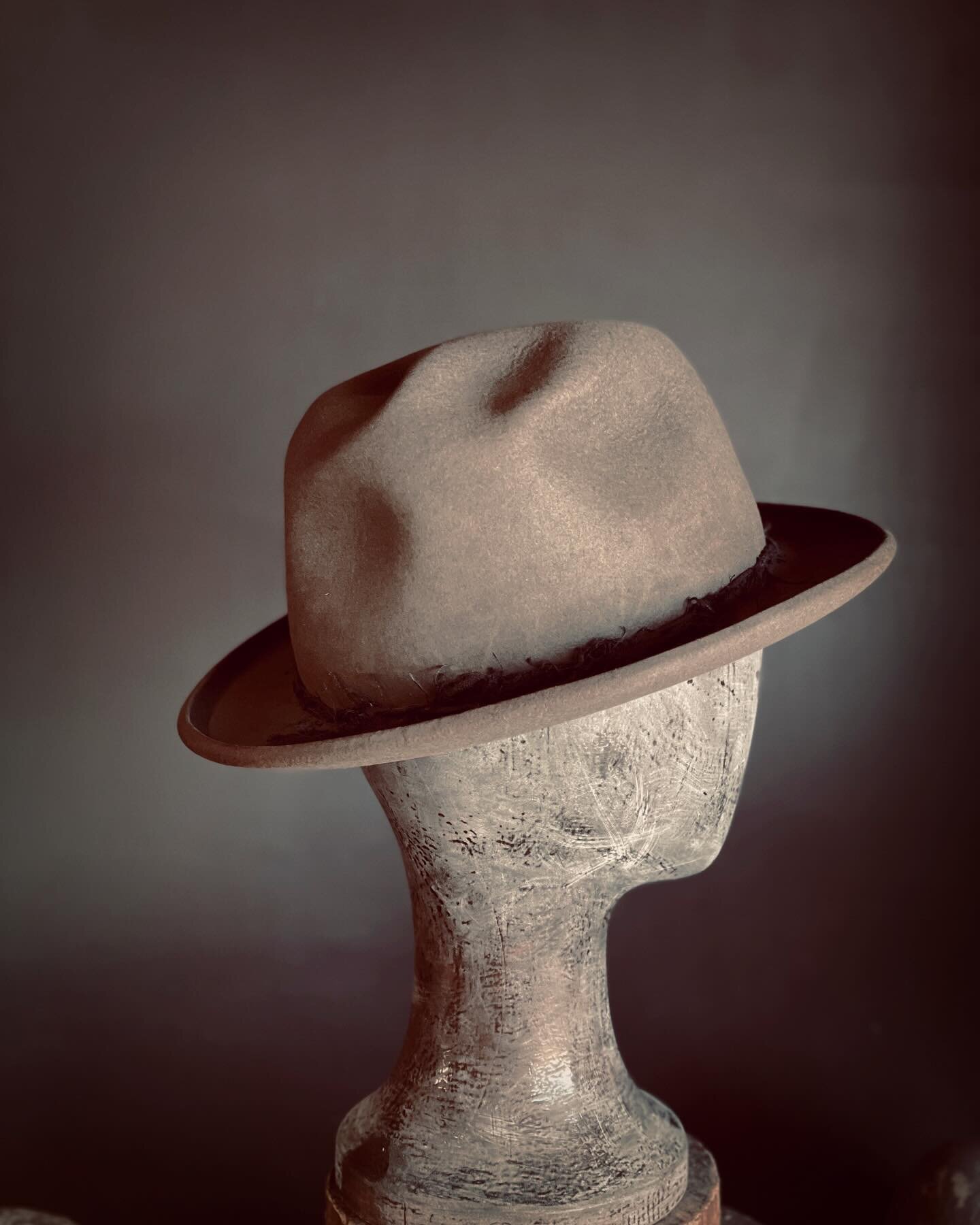 BOWLER BASH - A uniquely lumpy dark gray bowler with a short, curled brim. Its hat band is tied with aged raw-edged linen.  Supple black goat leather sweatband. Made to fit your head! (Any head size/shape). Turnaround time is generally 4 weeks. Find 