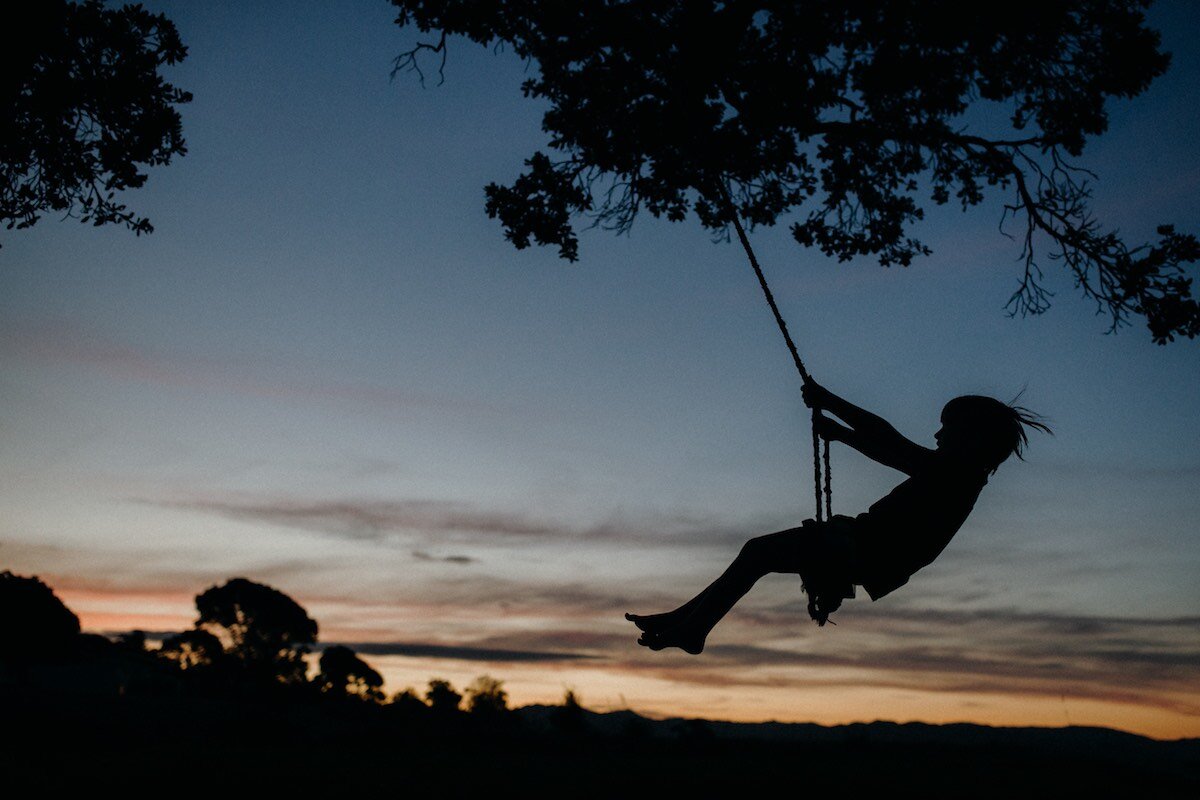 Photograph of child on swing at sunset - Emily Chalk.jpg