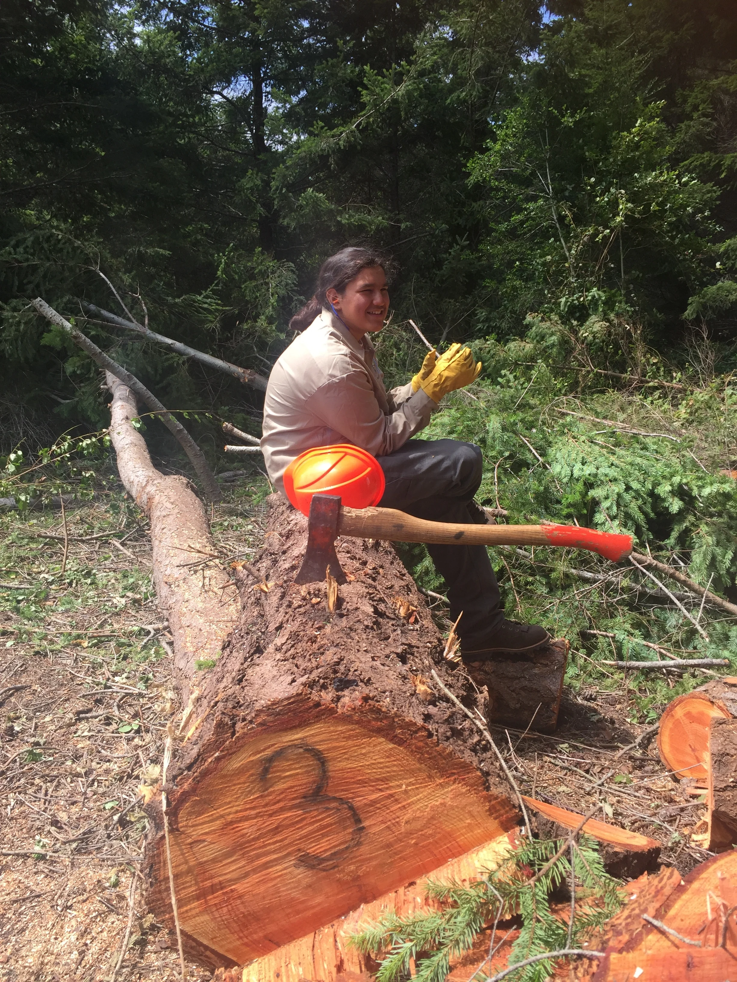 NSC intern resting from hard work making burn piles at restoration site
