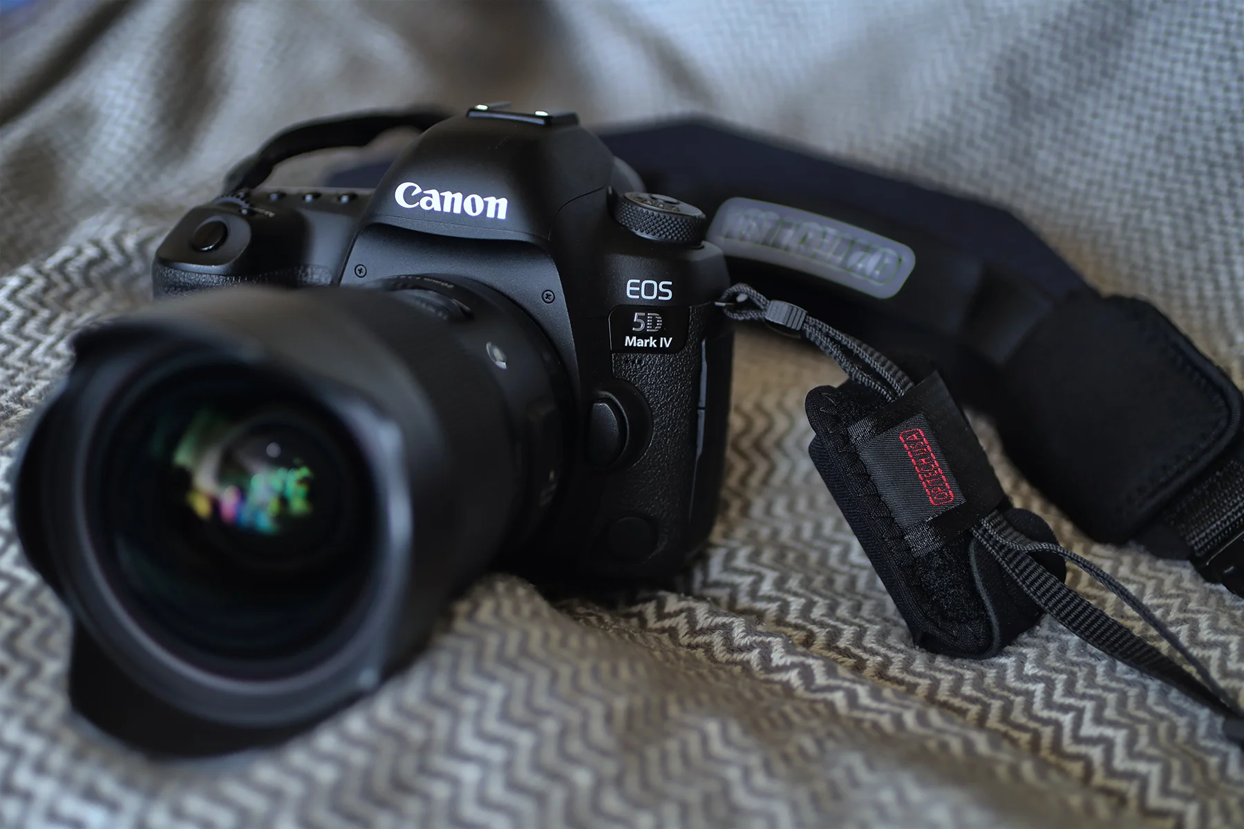 I attached it to the Optech USA Pro strap on my 5D Mark IV, but since I only mounted one of the battery holsters on the strap, it made my camera and strap combo feel like it was weighted unevenly. I think it would be fine if you have one on each sid…