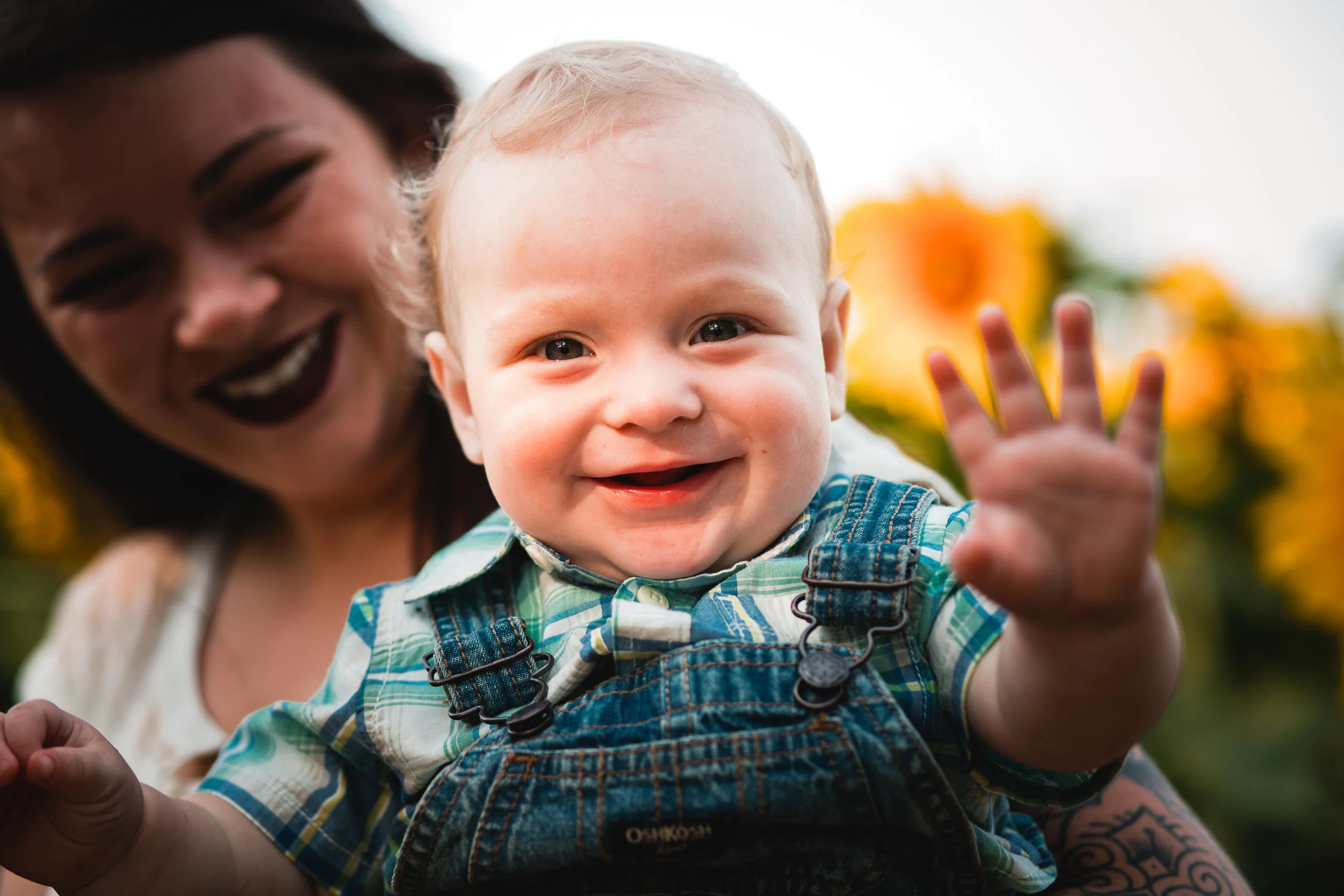 baby waving at camera