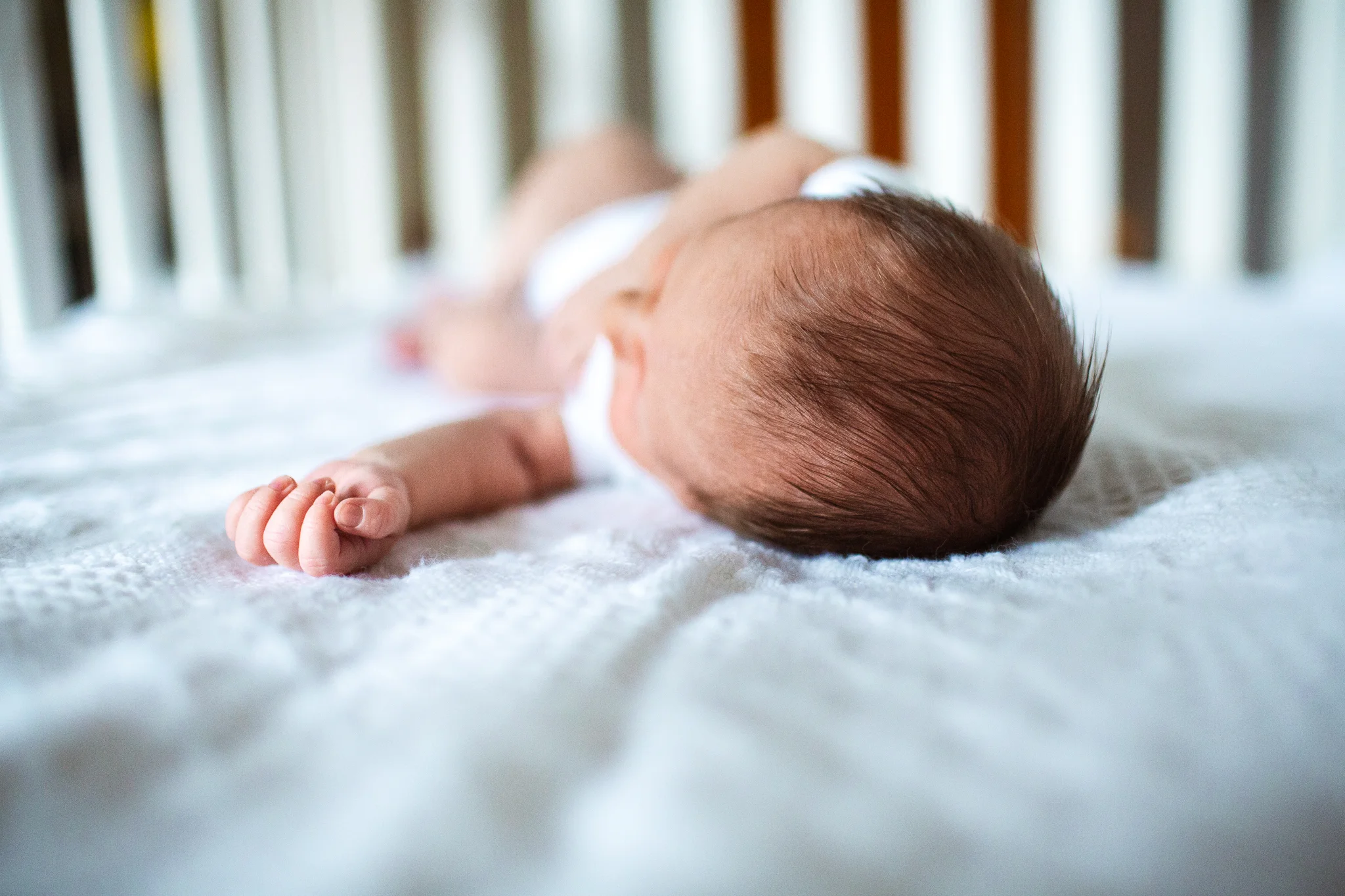 newborn sleeping in crib