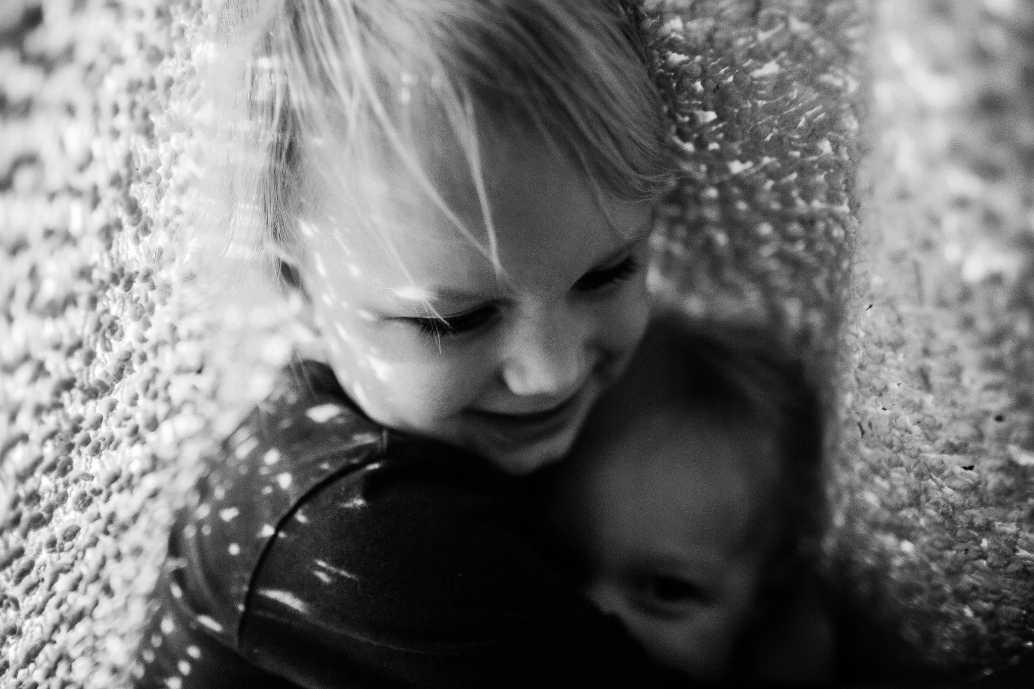 boys hugging under blanket