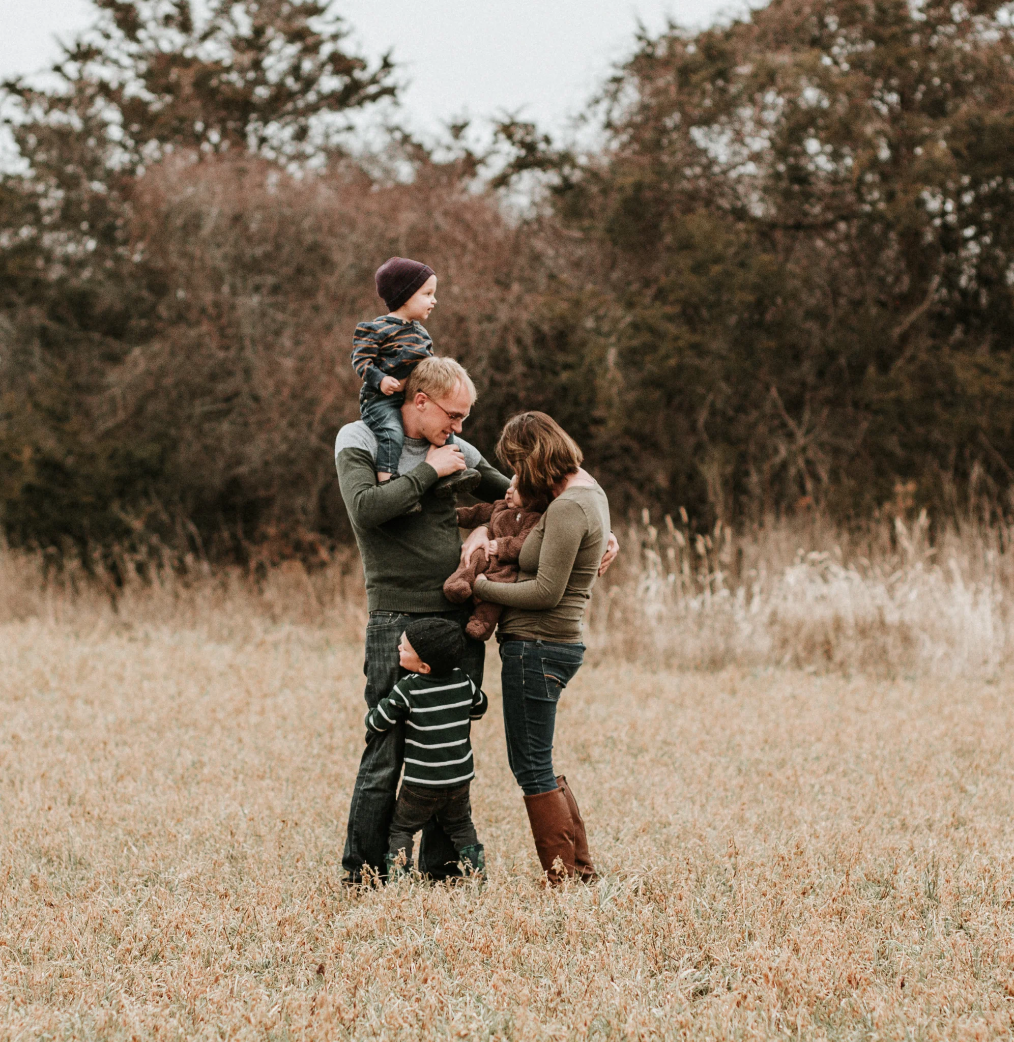 family hugging in field