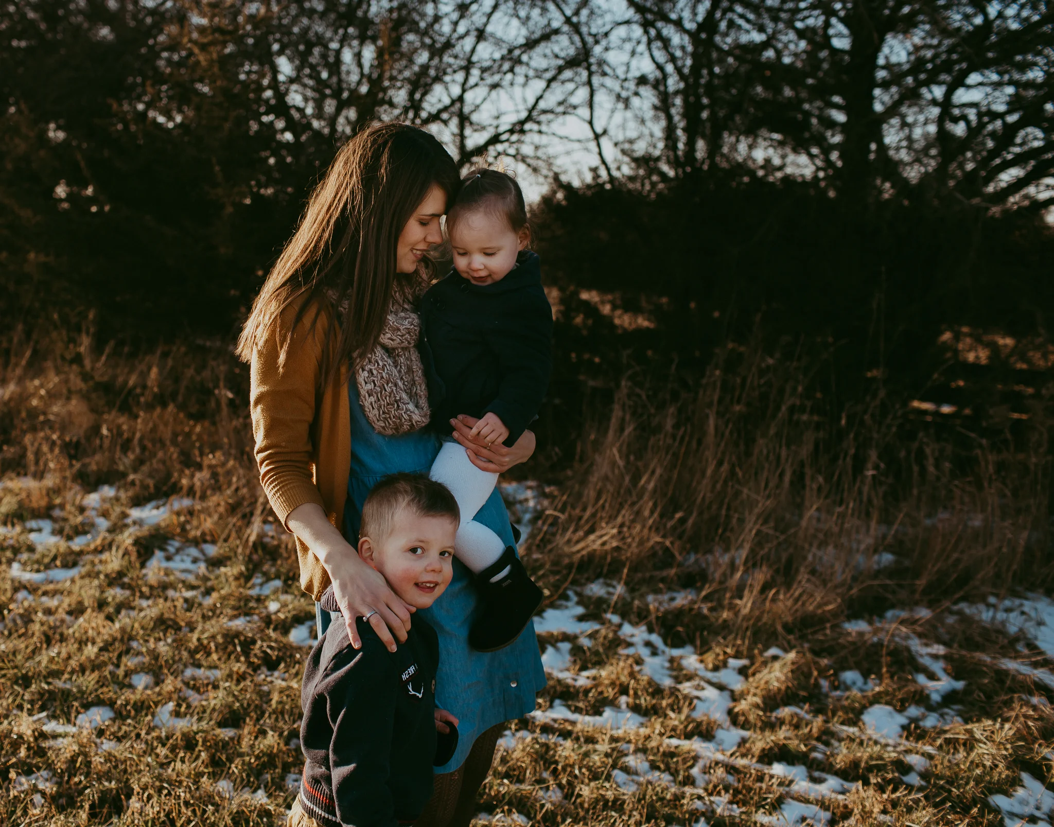 mom cuddling children