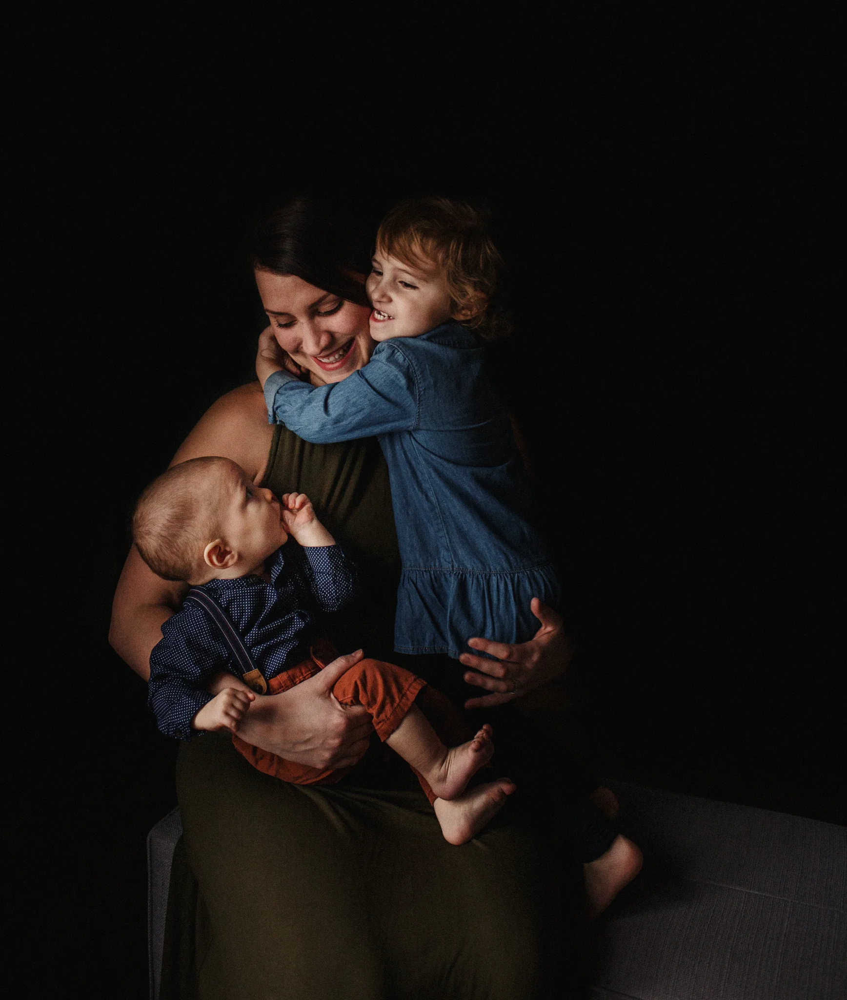 mom holding children in lap