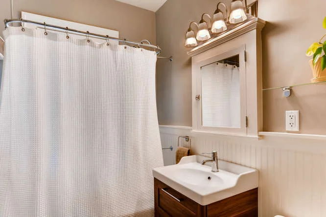 We did a light remodel in the bathroom in 2017, replacing the sink, vanity, and toilet and installing bead board and new baseboard. We kept the original marble hexagon tile on the floor - it is definitely weathered though, showing some pitting and cracks.