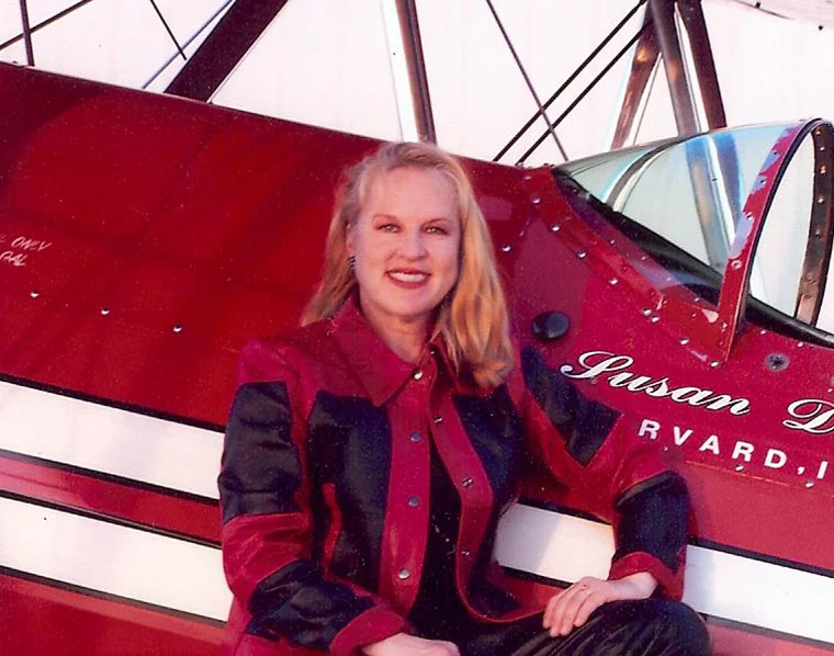 SUSAN DACY & BIG RED Susan will inspire young girls with her career story as one of the most accomplished female pilots in the world. When not flying her Stearman "Big Red", you can find her in the cockpit of an American Airlines Boeing 777.