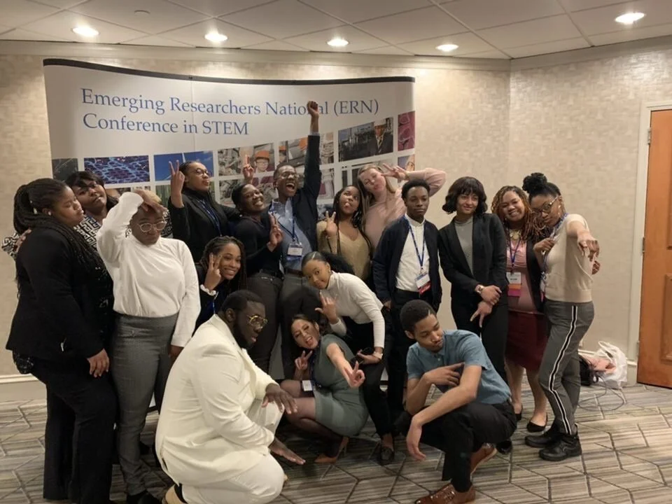 Derek McFarland (back row, center, with arm raised) and Lois Mack (back row, second from right), with fellow students from Harris-Stowe State University.