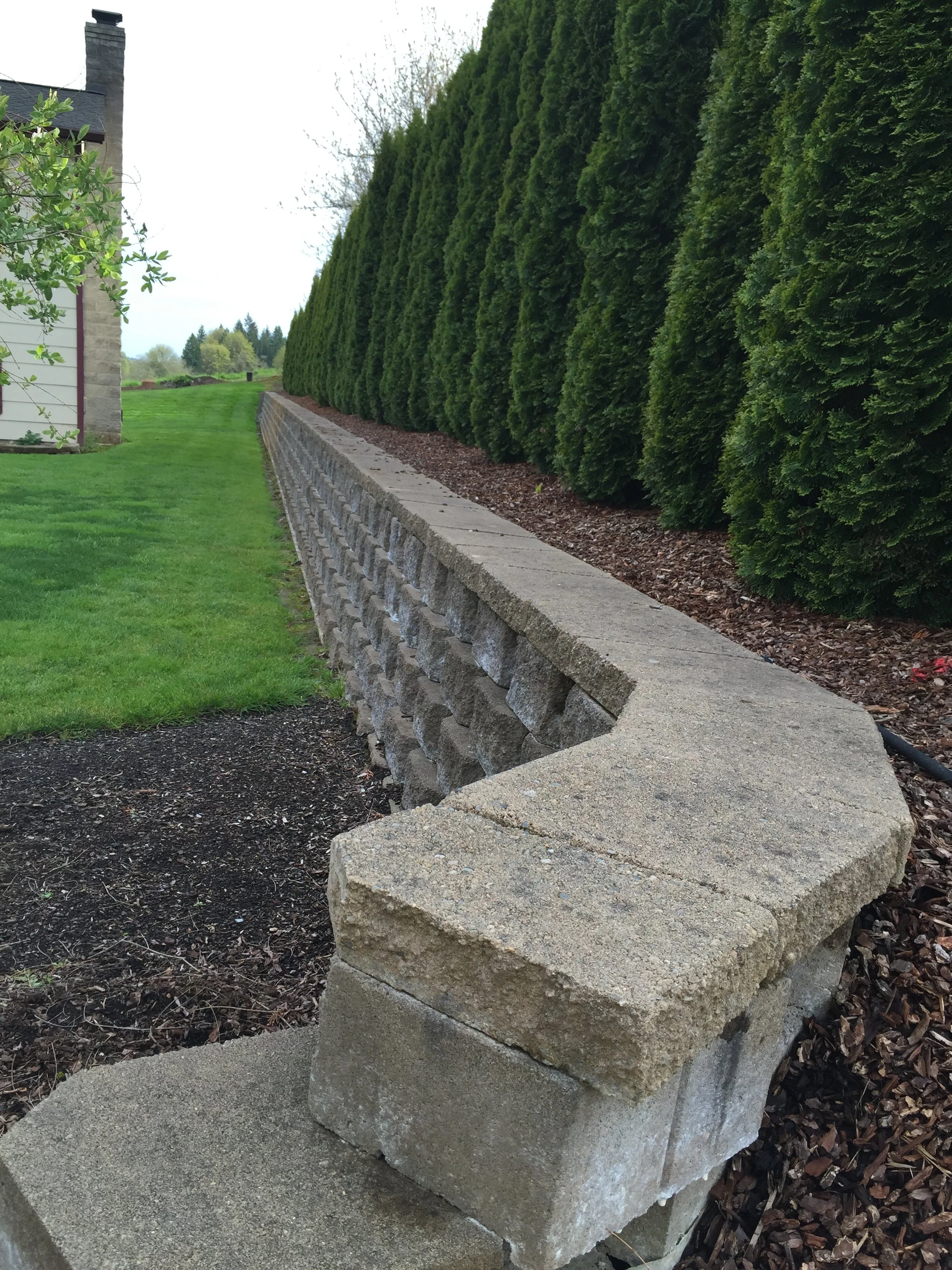 When a Retaining Wall Starts to Fail, Drainage Is Usually the Reason
