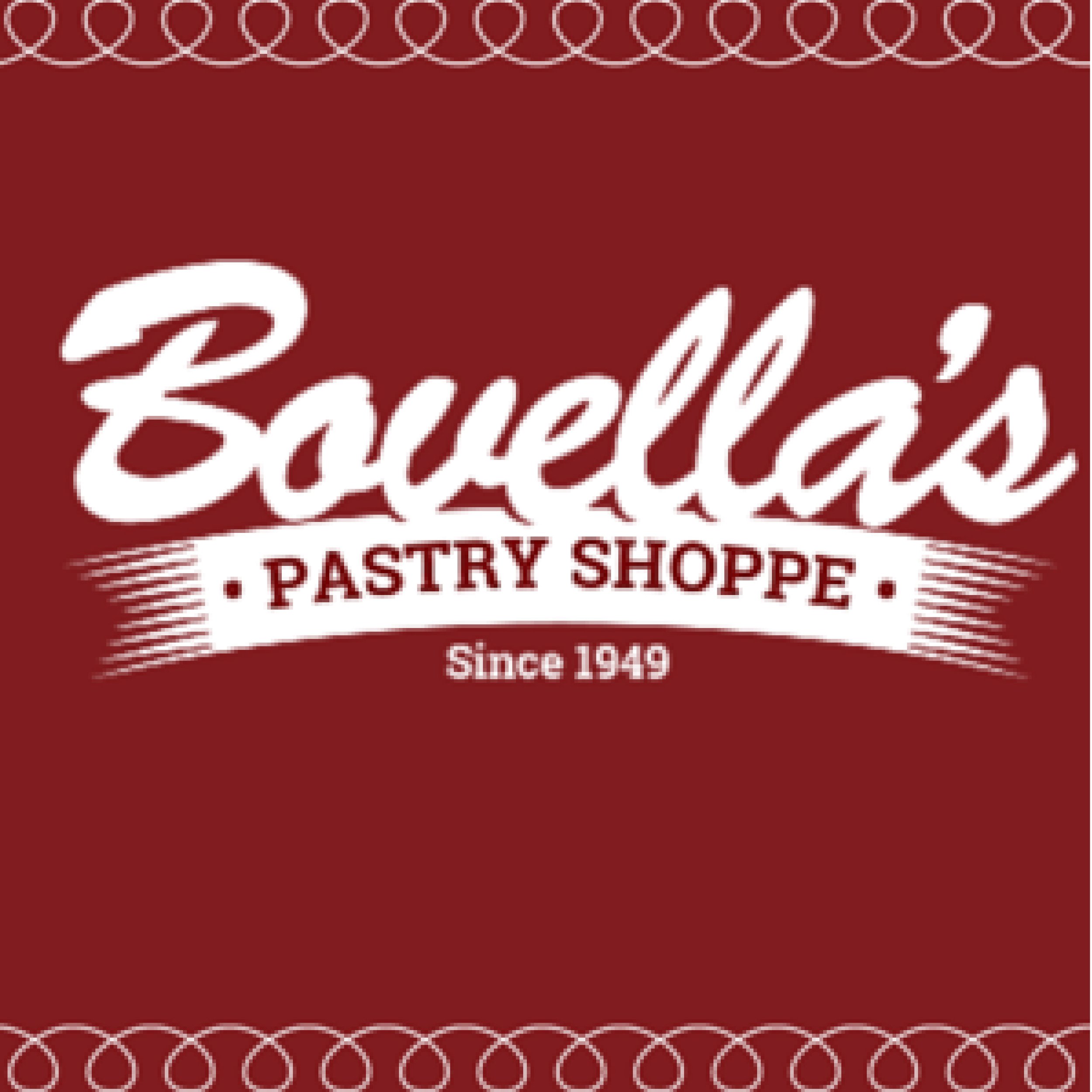 Red bakery sign with white cursive text that says "Bannings Bakery, Pastry Shoppe, Since 1949," decorated with a white rope-like border at the top and bottom.