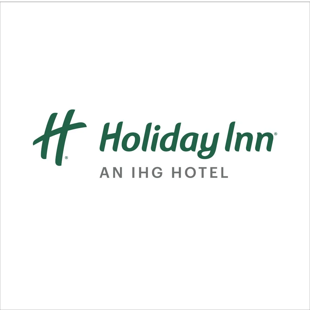Holiday Inn logo with green stylized 'H' and text 'Holiday Inn' in green, and smaller text 'AN IHG HOTEL' in gray.