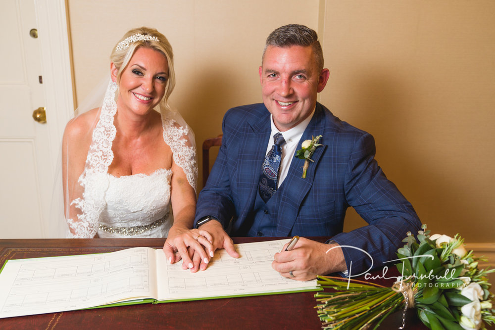 Bride and Groom Signing Register at Harrogate Register Office. Bride and groom at Harrogate Register Office. Wedding Photographer Yorkshire