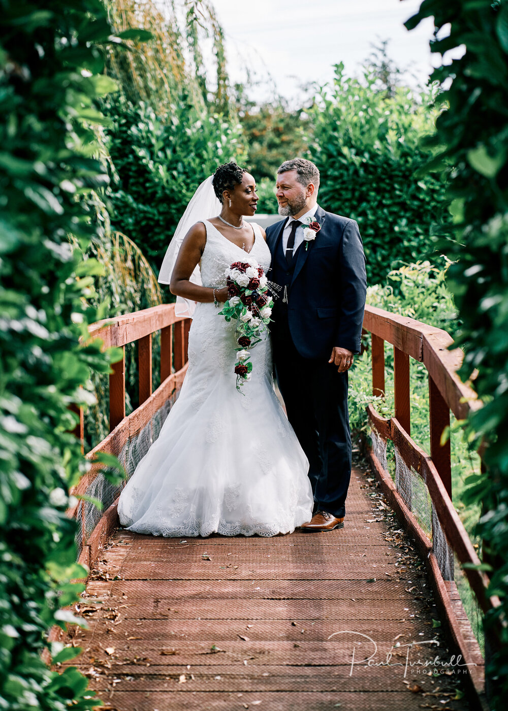 Bride and groom on the bridge in the gardens of Lazaat Hotel. Wedding photographer Hull