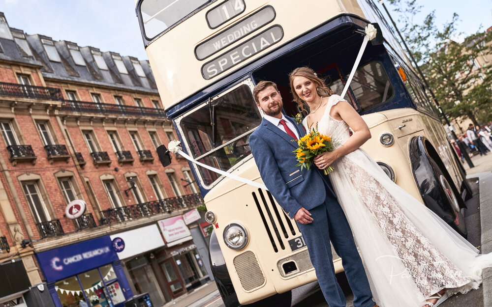 Newlyweds Pose with Vintage Bus. Wedding Photography at Sheffield Town Hall