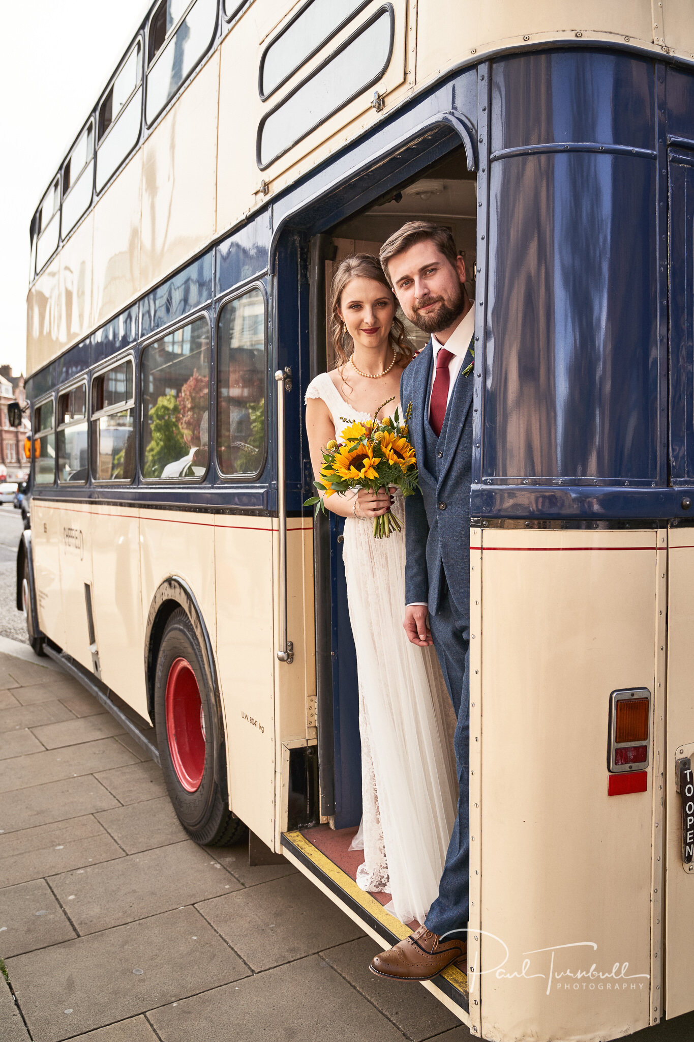 Newlyweds Pose with Vintage Bus. Wedding Photography at Sheffield Town Hall