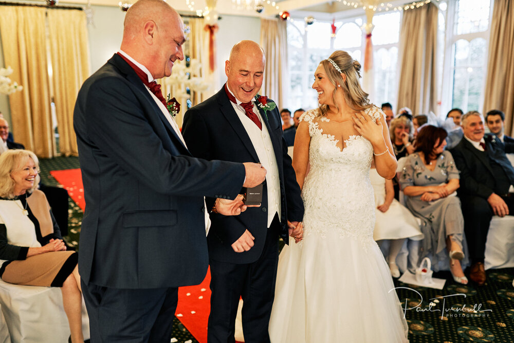 Best Man presents the rings to the bride and groom during Old Swan Hotel wedding ceremony