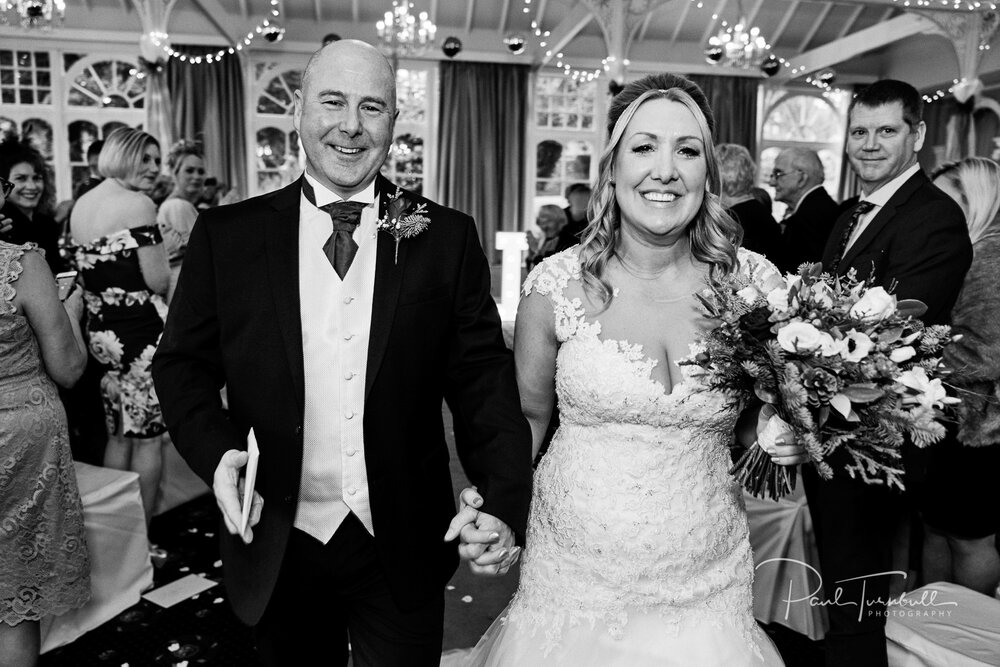 Black and White. Bride and groom exit Old Swan Hotel wedding ceremony