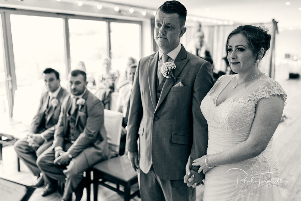 Wedding Photographer The Fleece, Bride and Groom Hold Hands During Ceremony