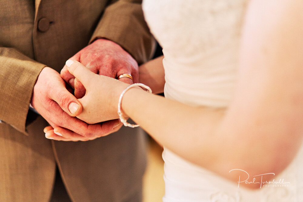 Wedding Photographer The Fleece, Closeup of Bride and Groom Holding Hands during Ceremony