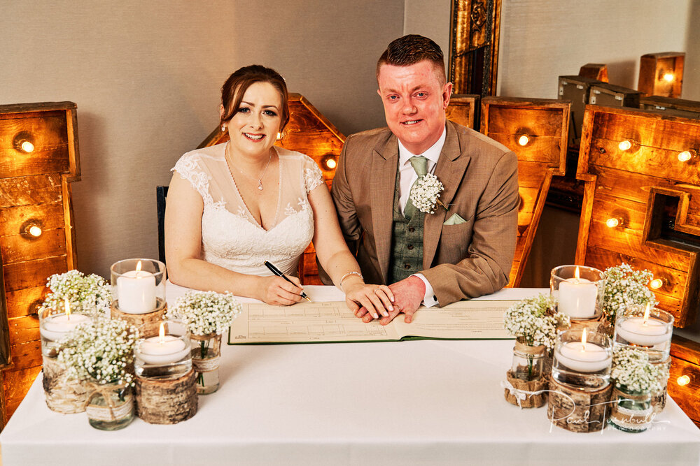 Wedding Photographer The Fleece, Bride and Groom Signing the Register