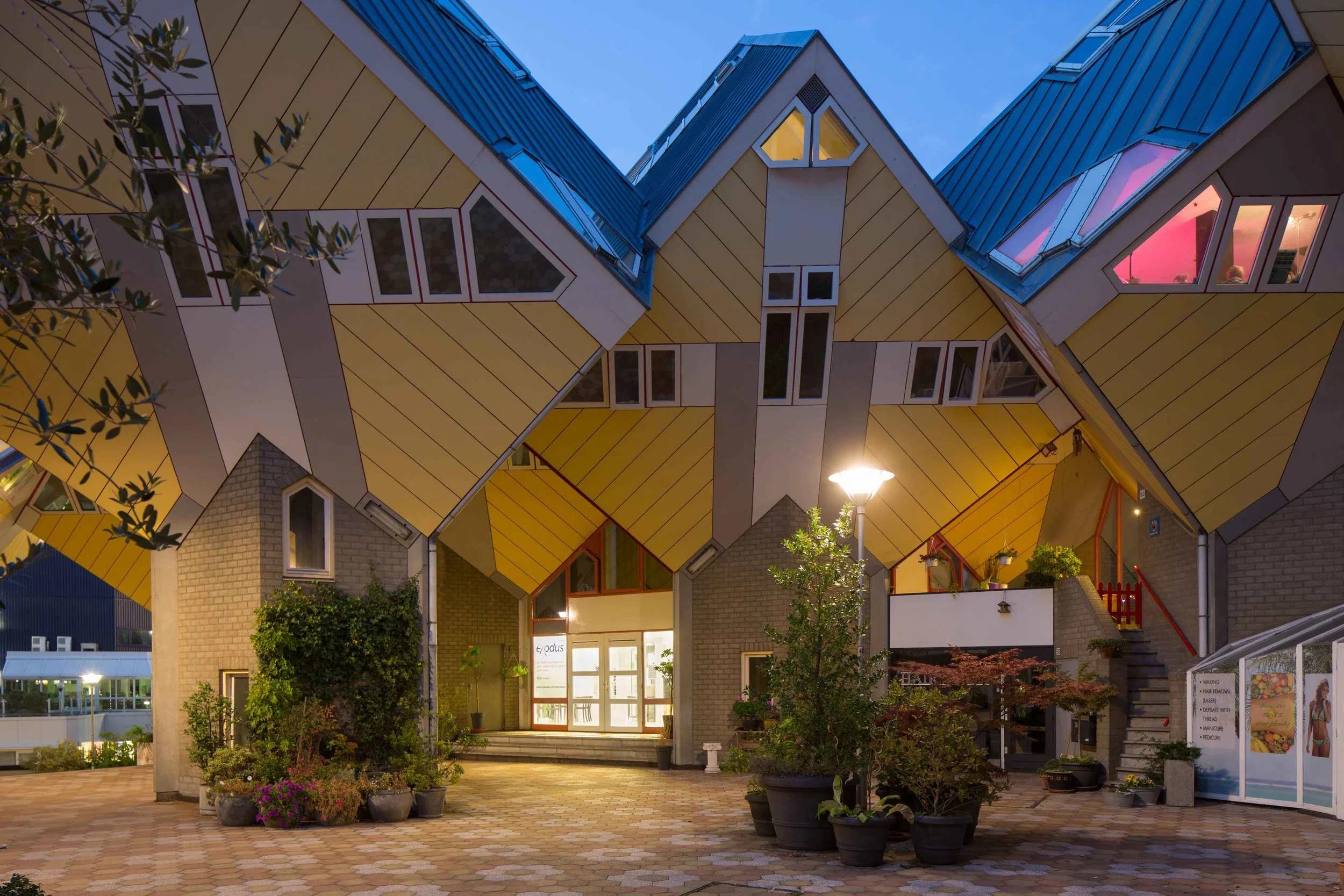 courtyard of the 'kubussen' with the brightly lit ground floor of the Exodus cube