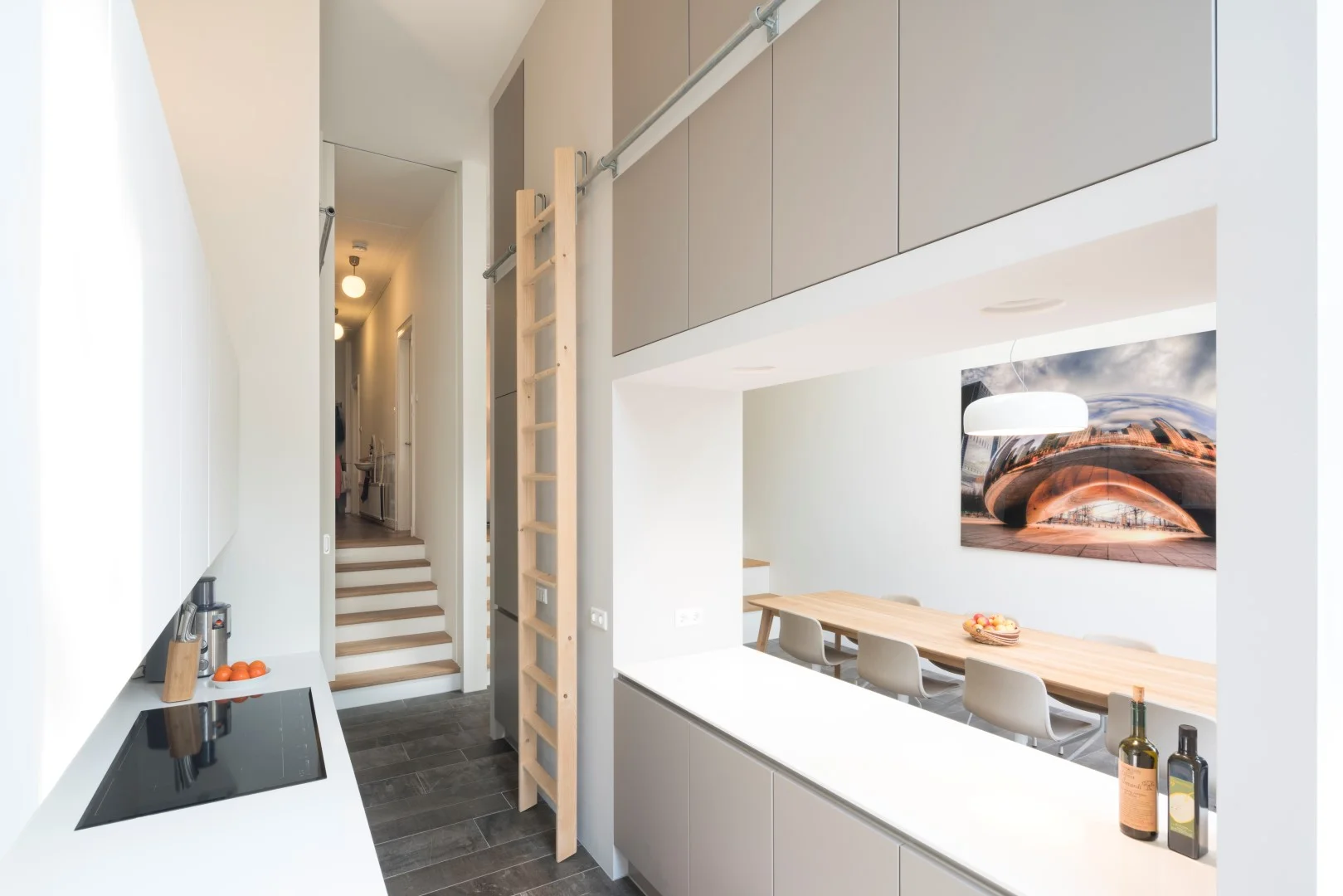 the large kitchen is separated from the dining room with a wall lined with cupboards that opens to the dining space