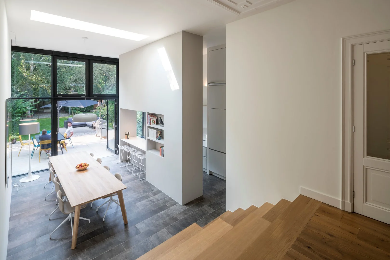 the ground floor extension with the wide tribune creating a gentle flow between the living room and garden level