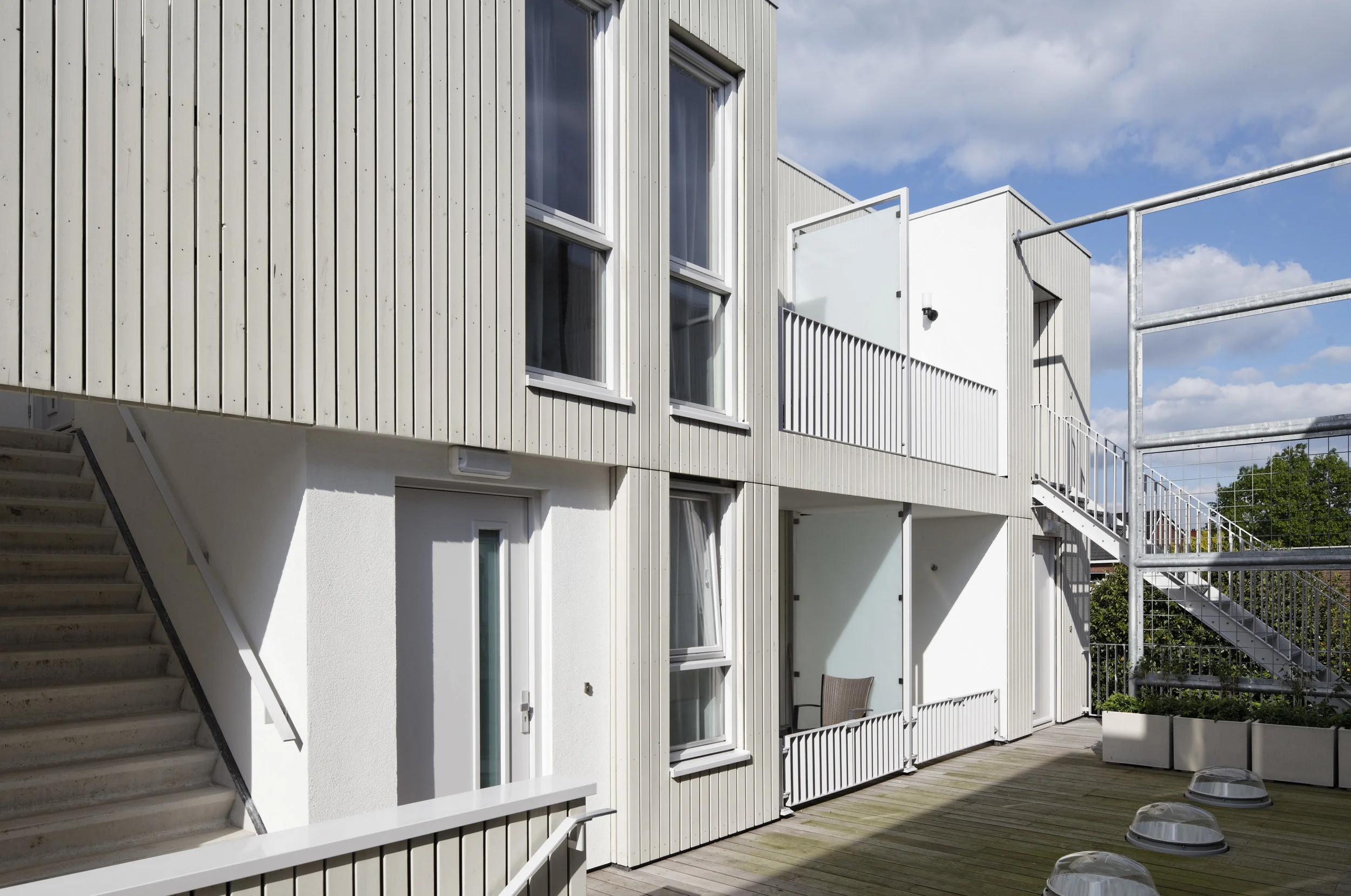 wood-clad facade looking onto elevated street