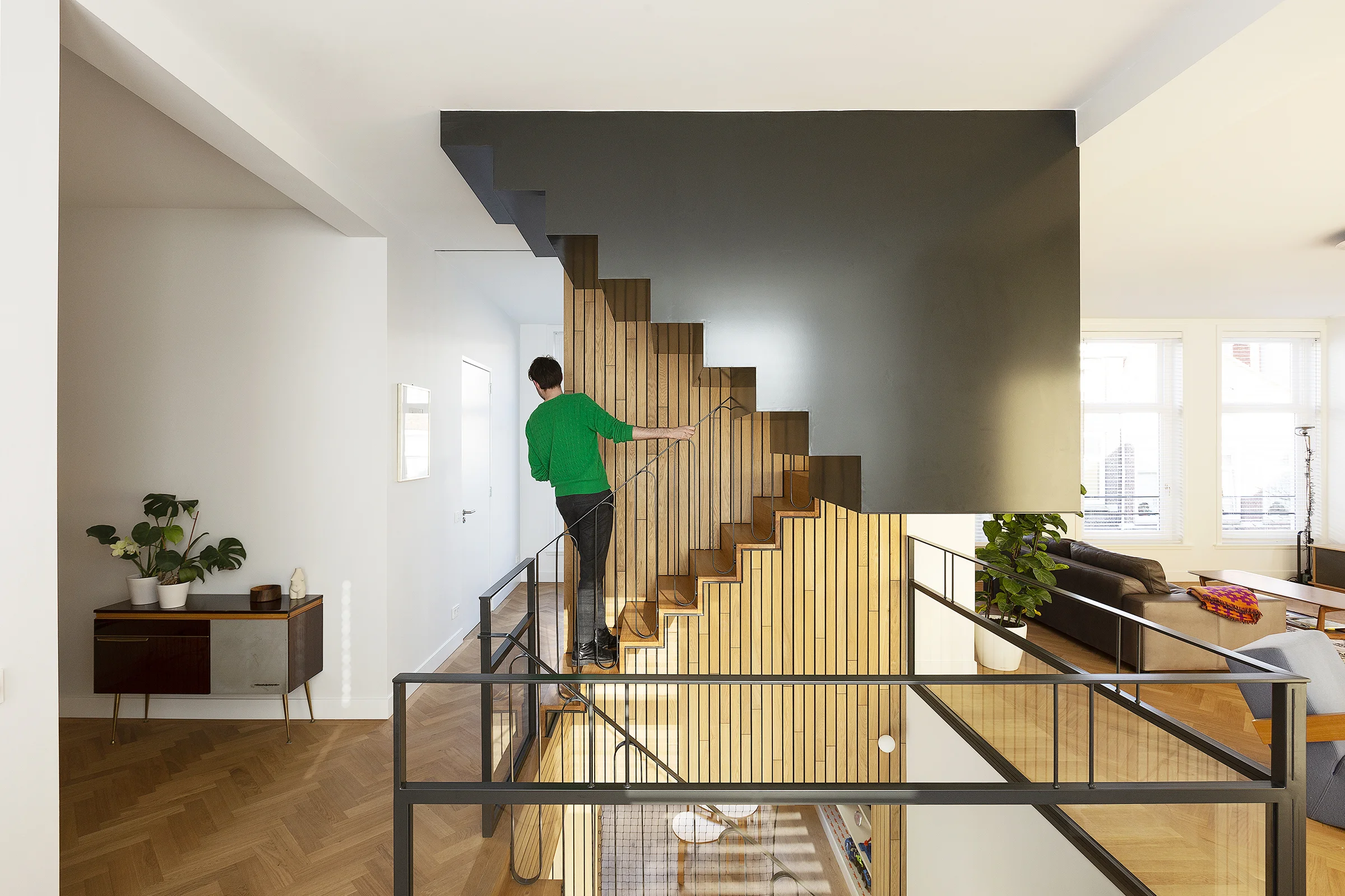 the first floor with the lounge area, living room, guest rooms and the visual connection with the ground floor