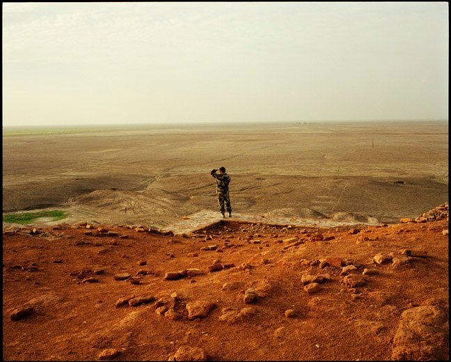  Italian soldier looks out across Mesopotamian plain from on top the Ziggurat at Ur. July, 2004.&nbsp;   