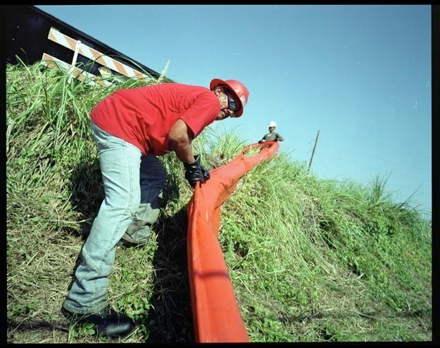  Worker for Andersen Pollution Control cleans up oil spill at Valero facility in Port Arthur, Texas, September 27, 2005.   