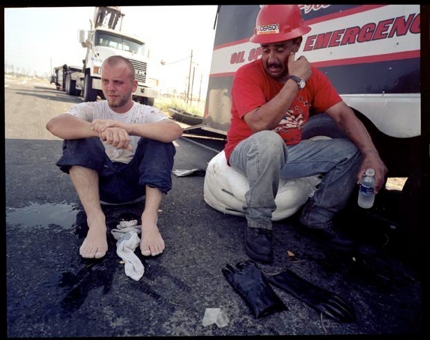 Worker for Andersen Pollution Control rests during cleanup of oil spill at Valero facility in Port Arthur, Texas, September 27, 2005.