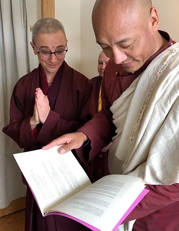 Ven. Thubten Saldon shows Anam Thubten Pema Chöling's newly assembled and printed daily prayer book.