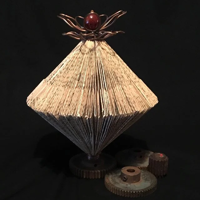 Graceful, yet industrial: Graceful Gears. Available now! Visit www.prettybirddesign.com #interiordesign #graceful #foldedbooks #booksculpture #books #mixedmedia #studioart #customart #customdesign #homedecor #coffeetabledecor #coffeetablebooks #coffe