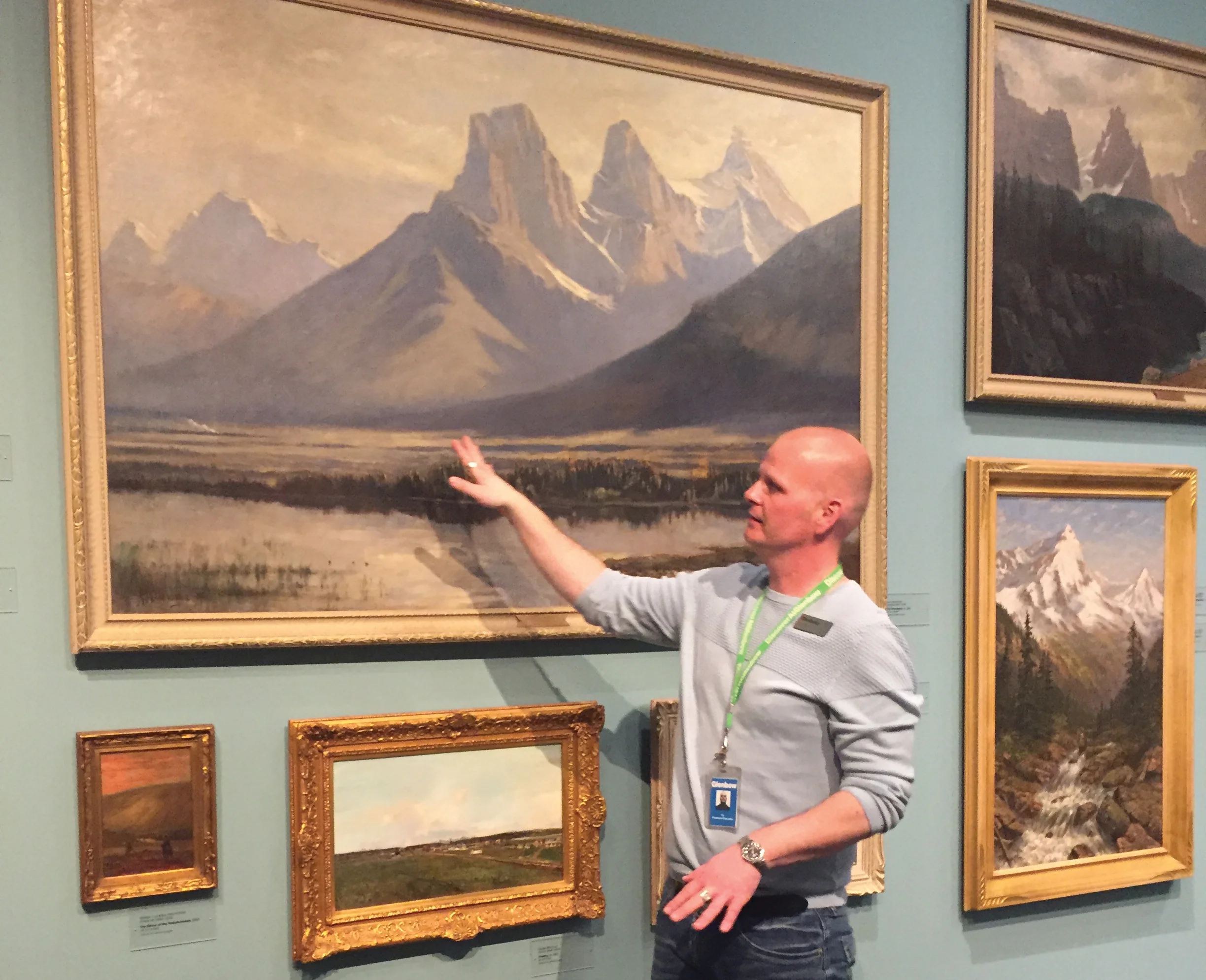 Glenbow educator Ty Larner points out some familiar landscapes to evoke memories during a dementia-friendly guided gallery tour. Photo courtesy Glenbow Museum.