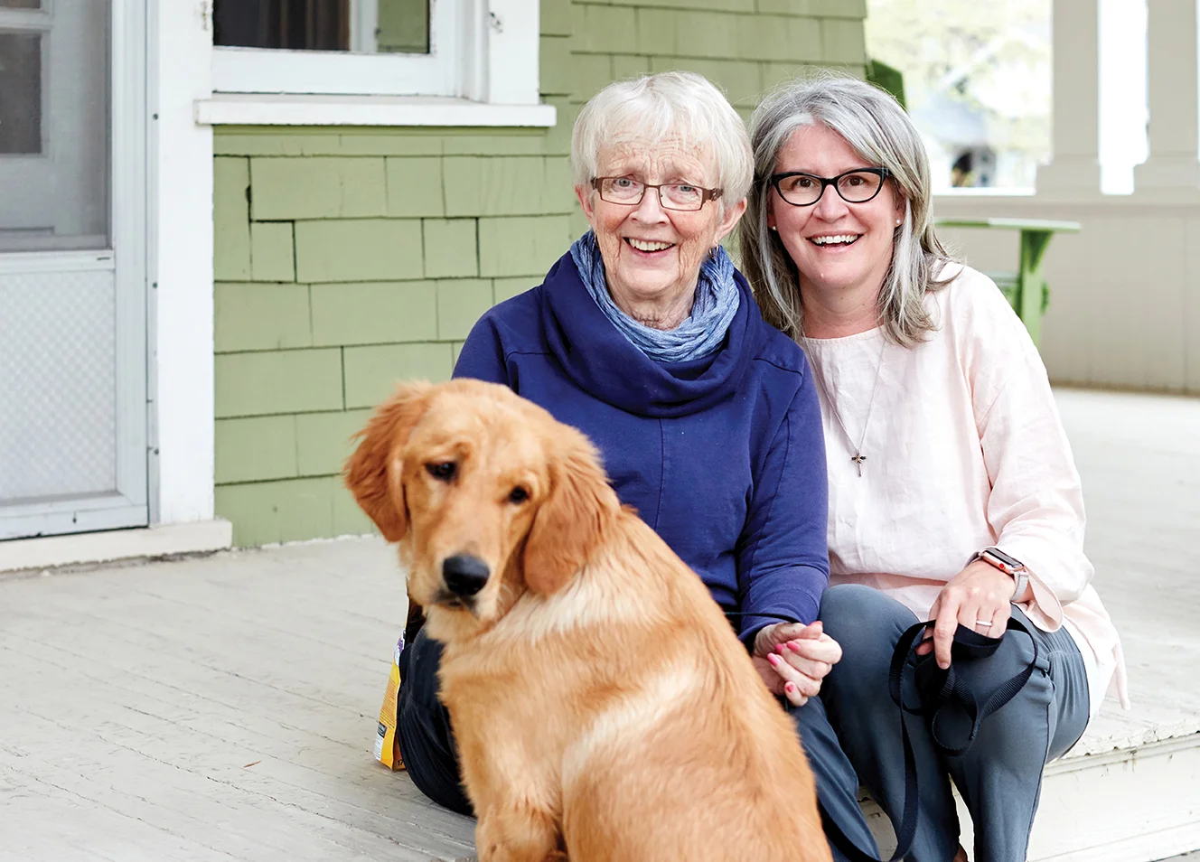 Glenbow tour participant Anne Stenhouse, centre, with Aspen Care Calgary executive director Shelley McLellan and canine friend Newman. Photographed by Erin Brooke Burns.