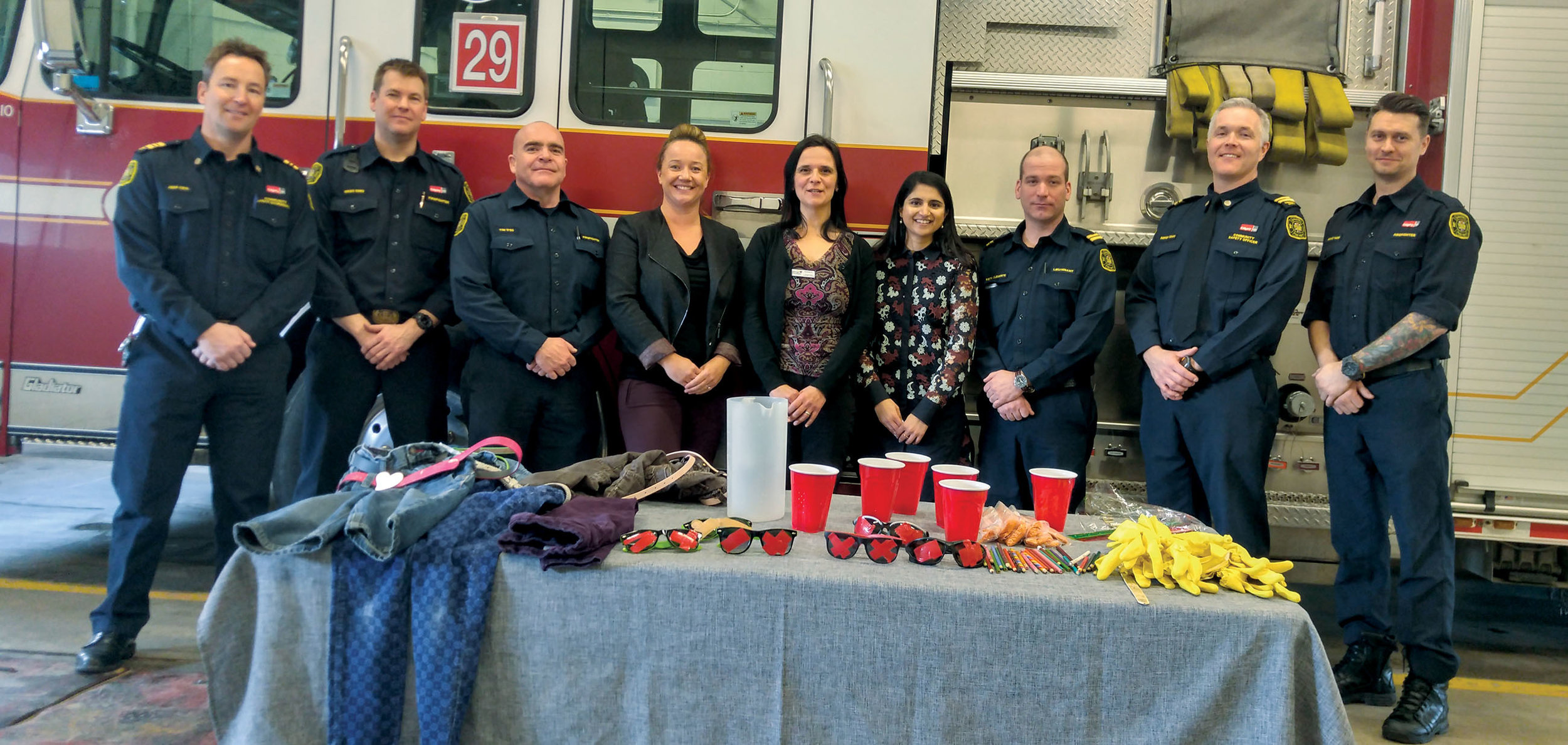 Firefighters, City staff and representatives from the Brenda Strafford Foundation stand together in Station 29 after a dementia awareness training exercise, part of the Dementia Friendly Communities partnership between the organizations.