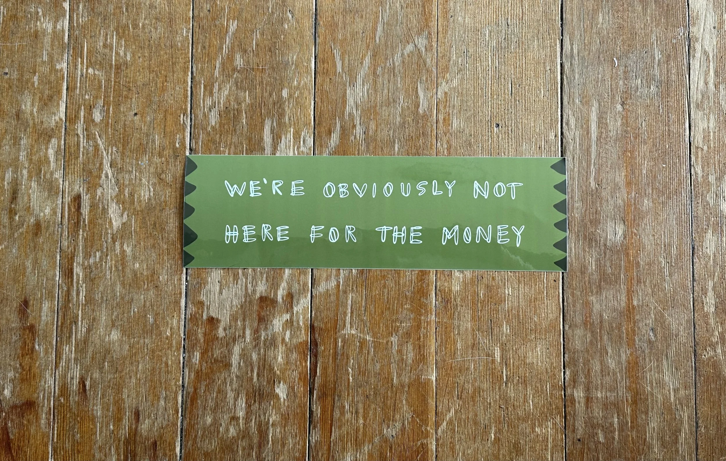 Bumper Sticker Saying "We're Obviously Not Here For The Money"